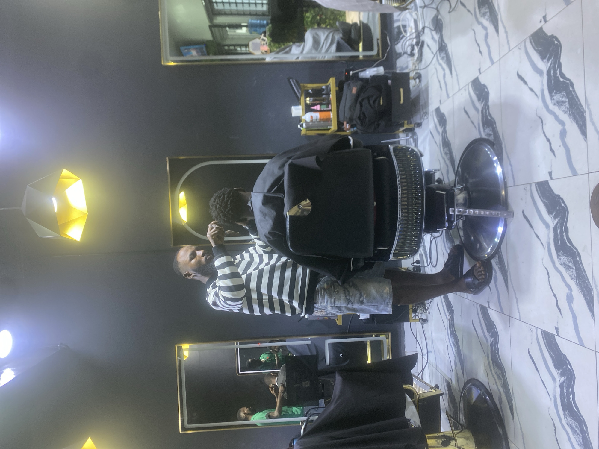 Barbershop activity documented in Lugbe, Nigeria during afternoon hours