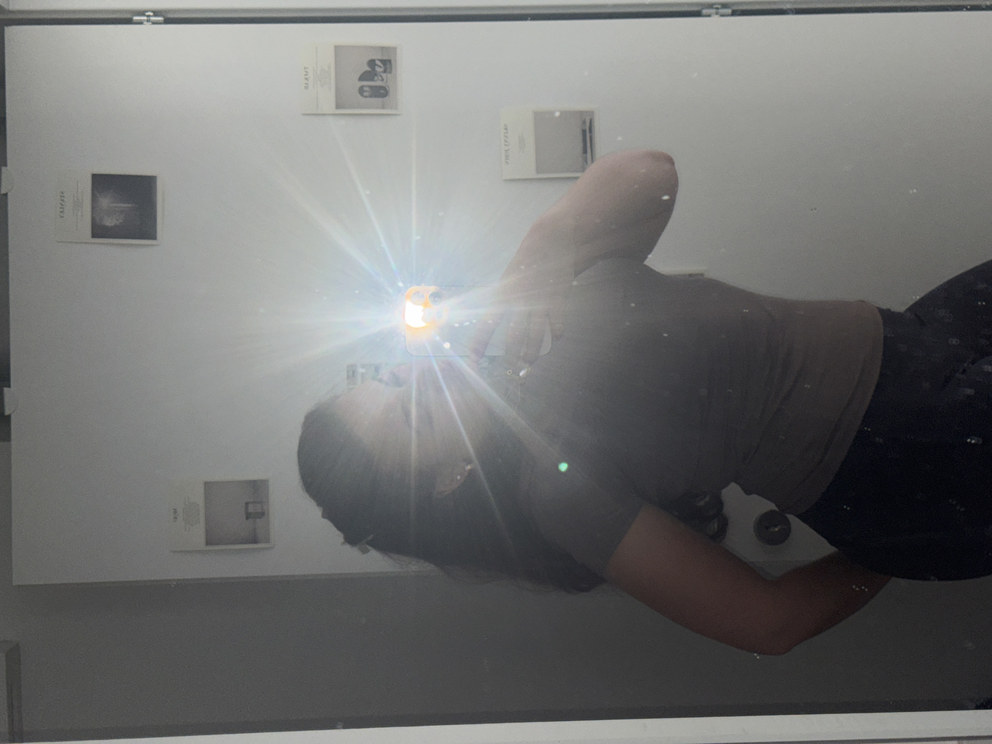 Mirror selfie with flash captured in Milan indoor setting