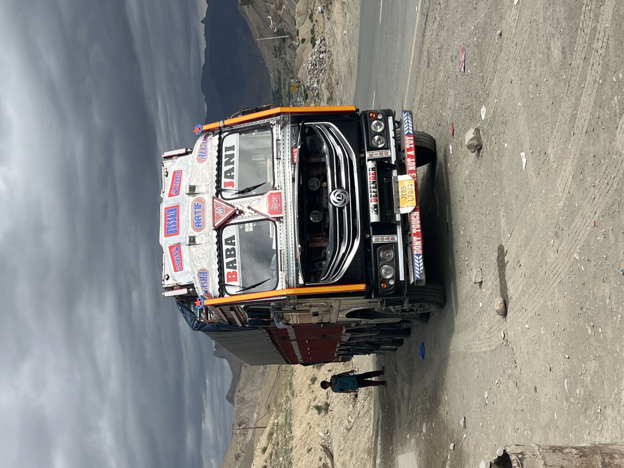 Decorated truck parked on a dusty mountain road in India