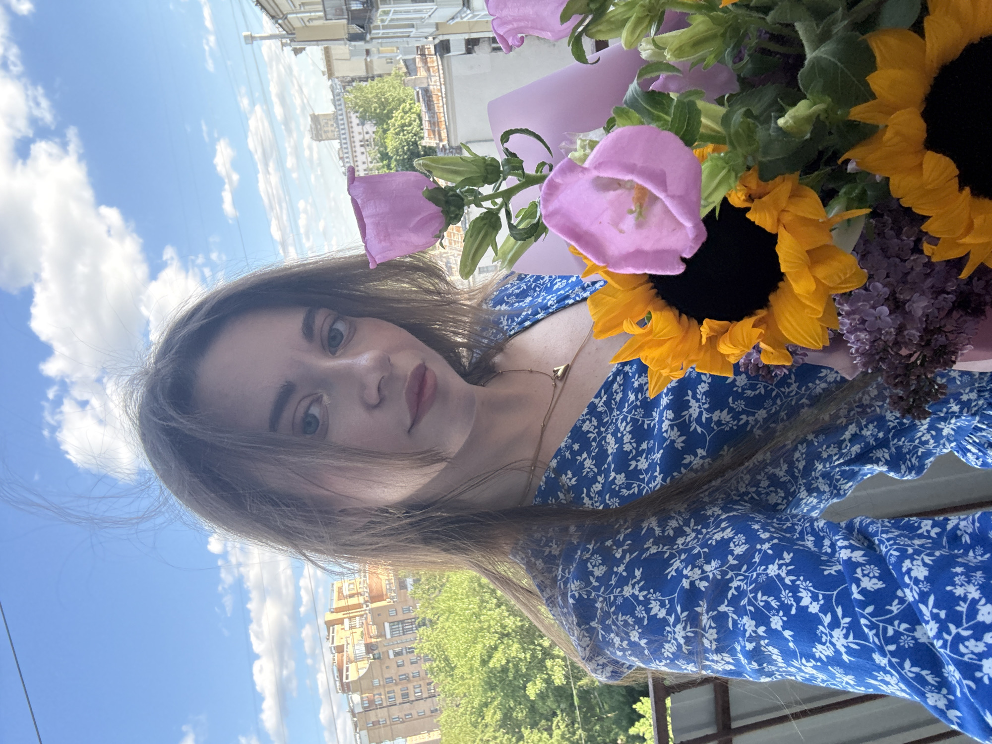Woman takes flower bouquet selfie in Moscow