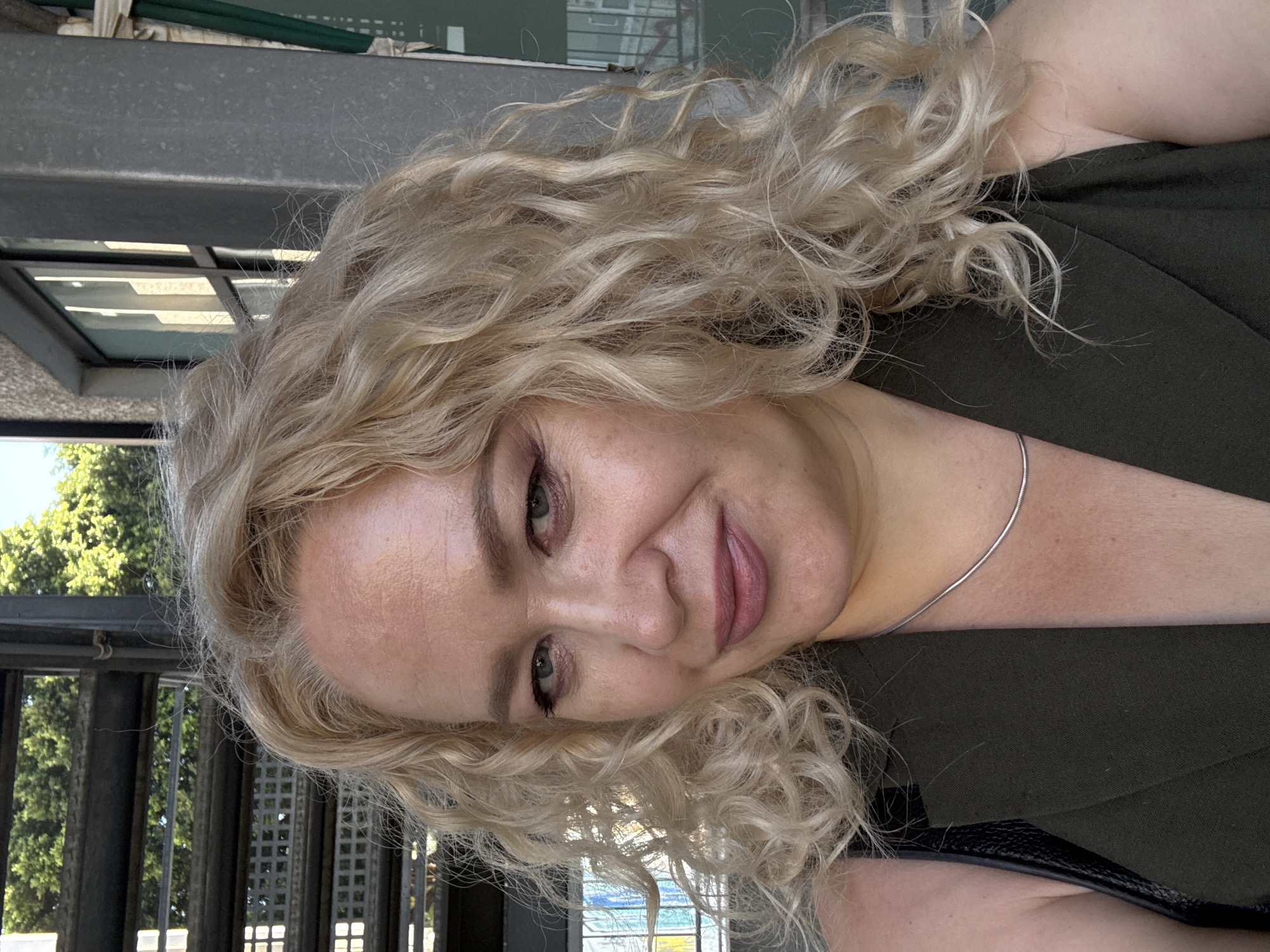 Outdoor selfie in Tel Aviv with urban greenery backdrop