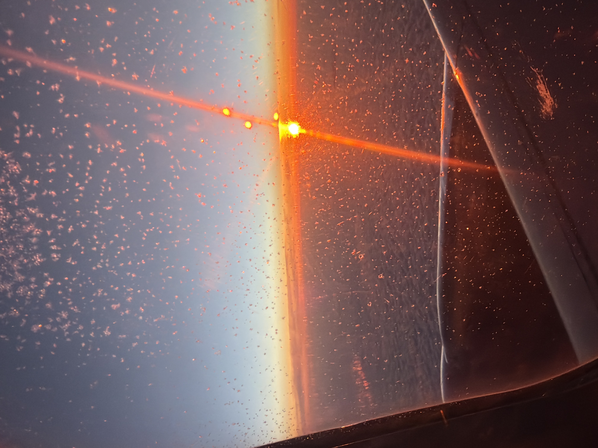 Aerial witness captures brilliant orange sun view from aircraft window