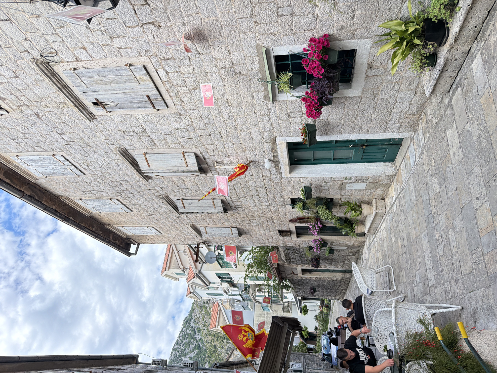 Tourist documents historic architecture and harbor in Risan, Montenegro