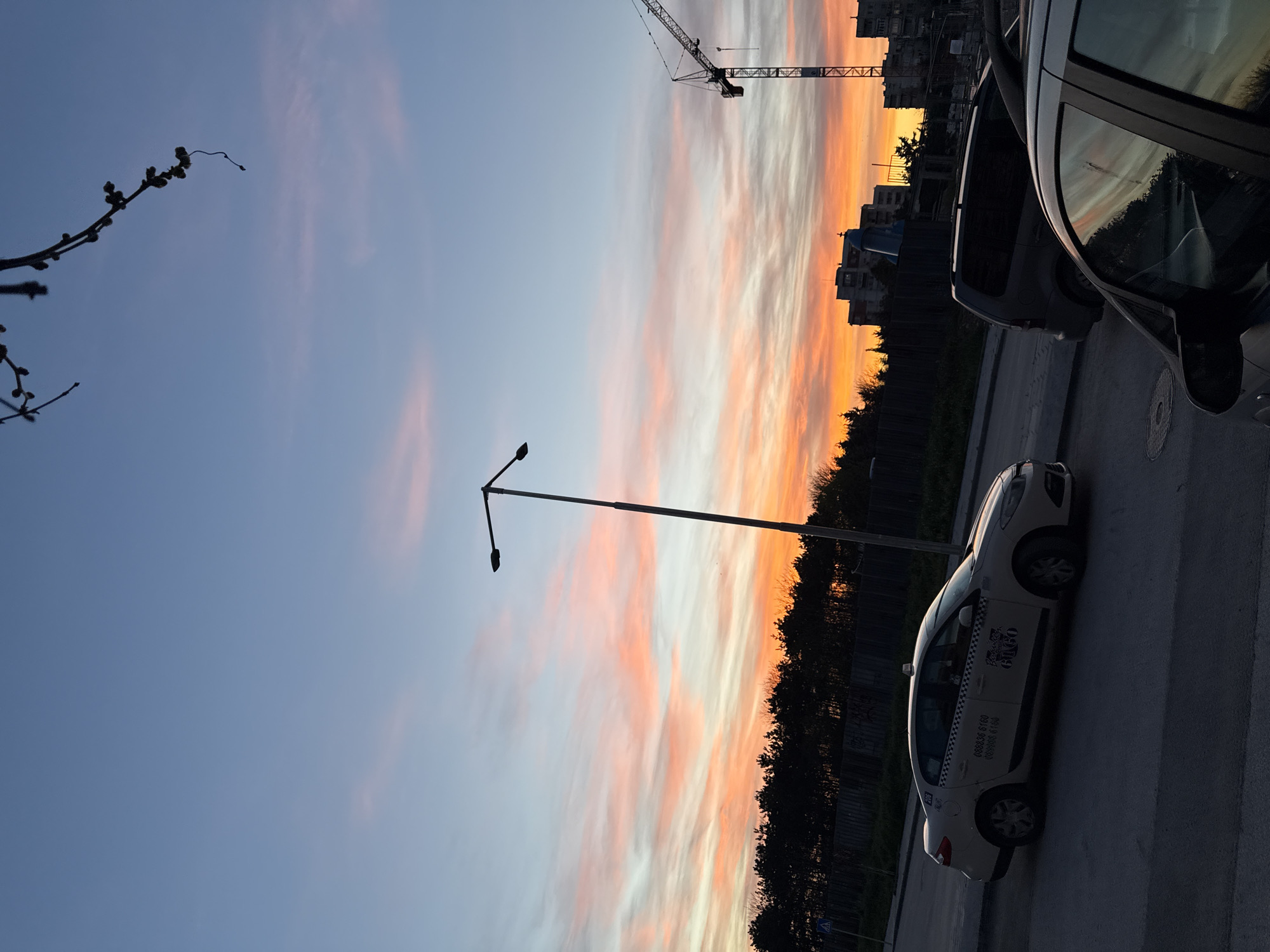 Sunset observed over Plovdiv street scene with construction crane