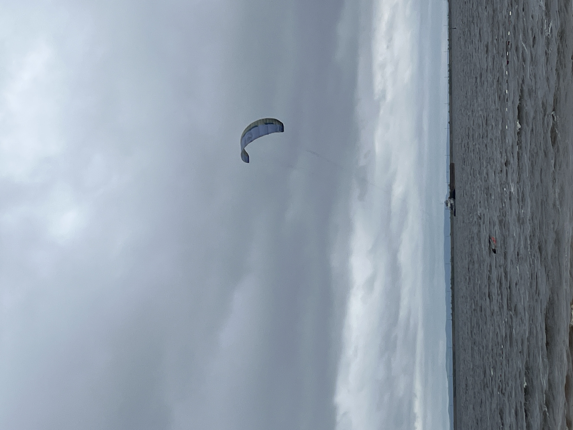Kitesurfers ride choppy Kama Reservoir on a cloudy July morning