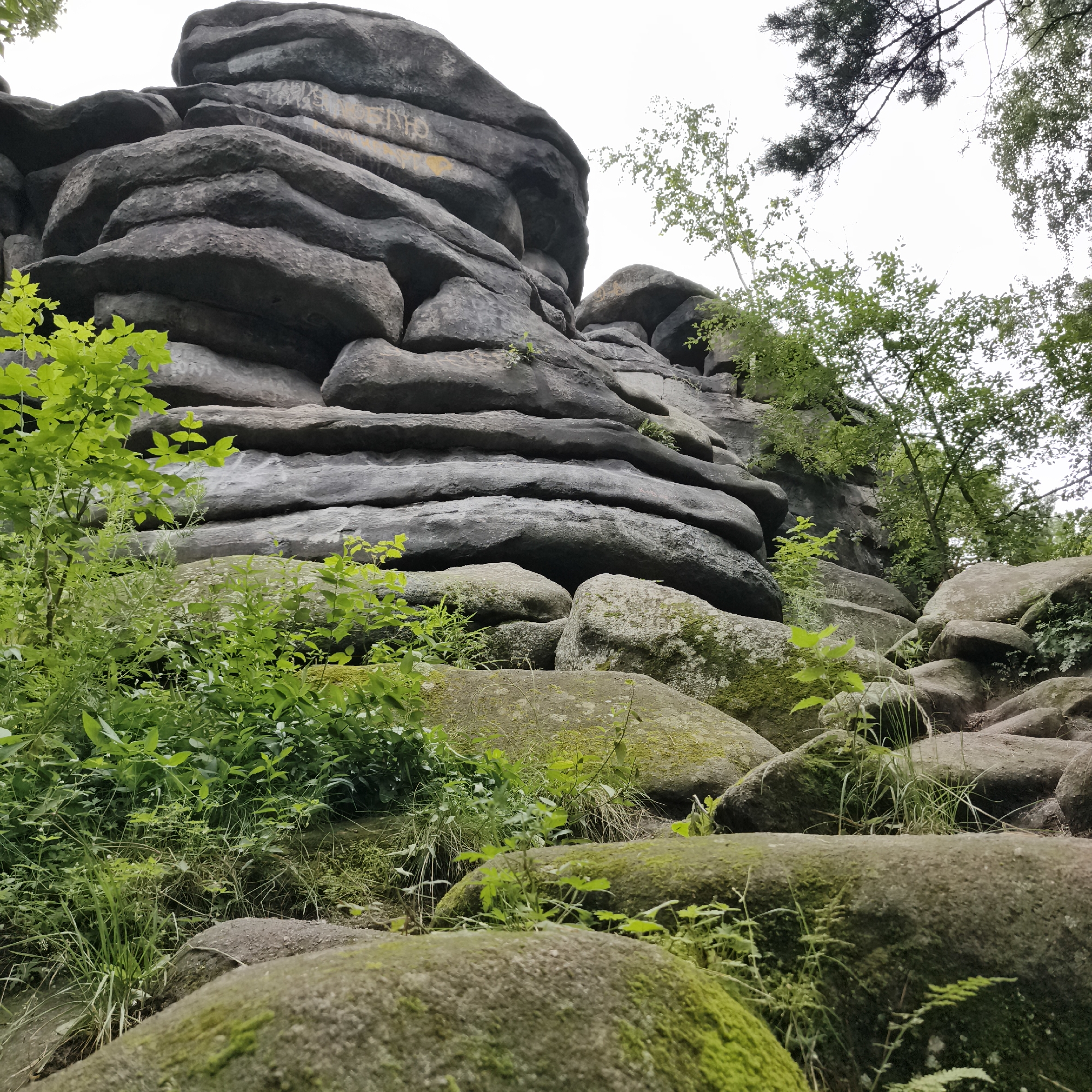 Exploring a mossy urban rock formation in Yekaterinburg's forest park