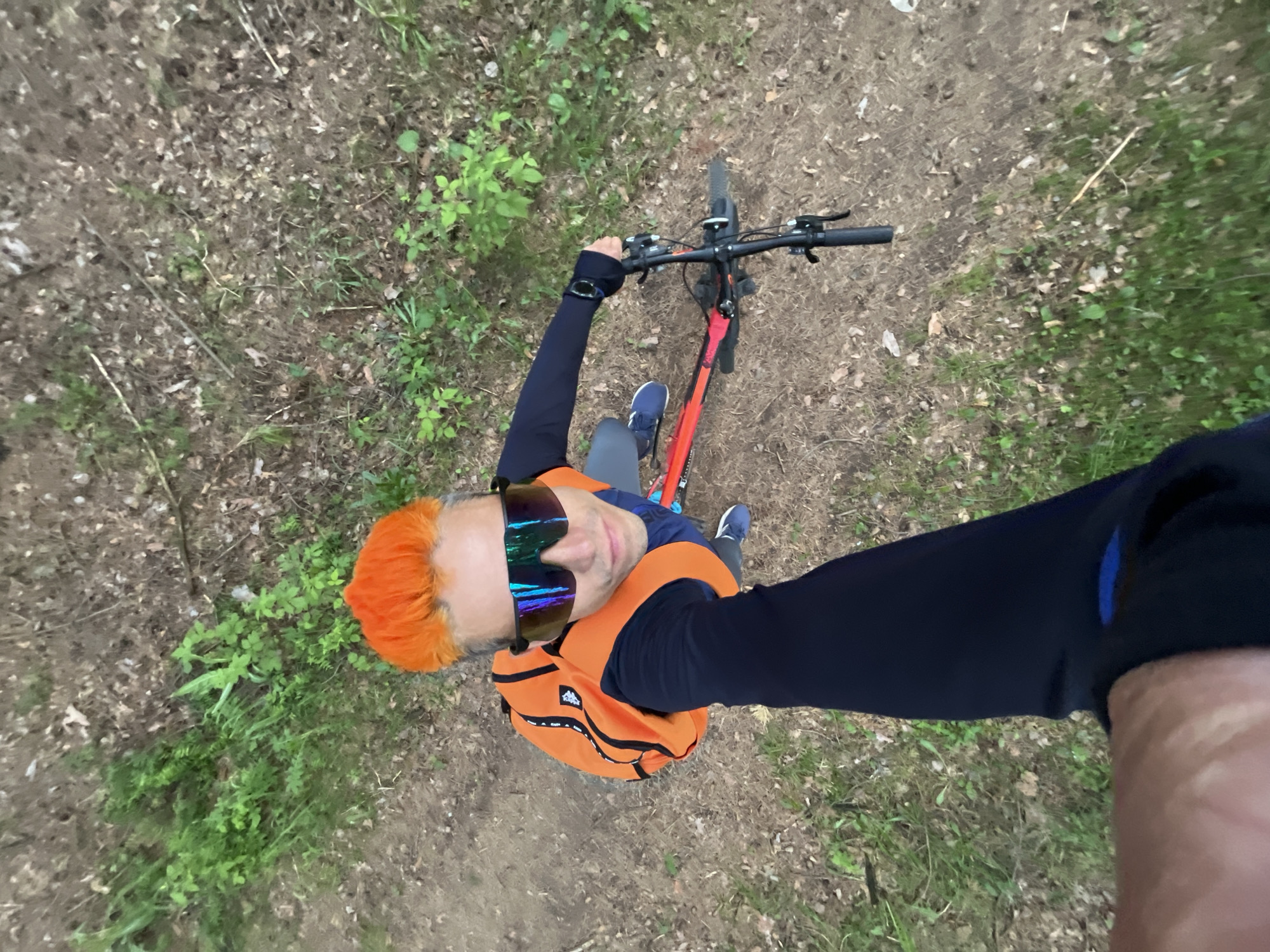 Orange-haired cyclist photographed during woodland outing in Chaikovsky, Russia
