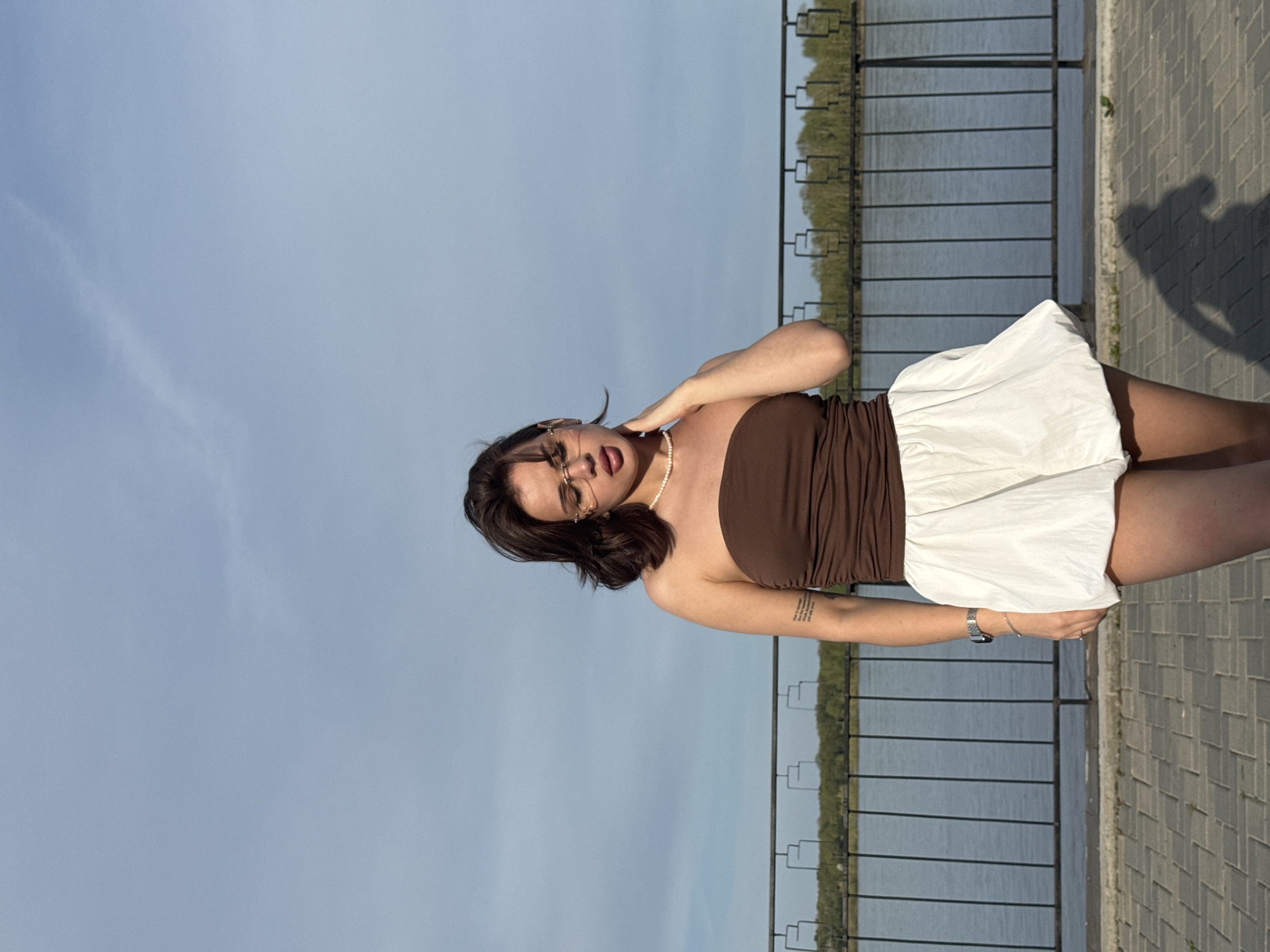 Woman poses for photos along Kama River waterfront in Sarapul