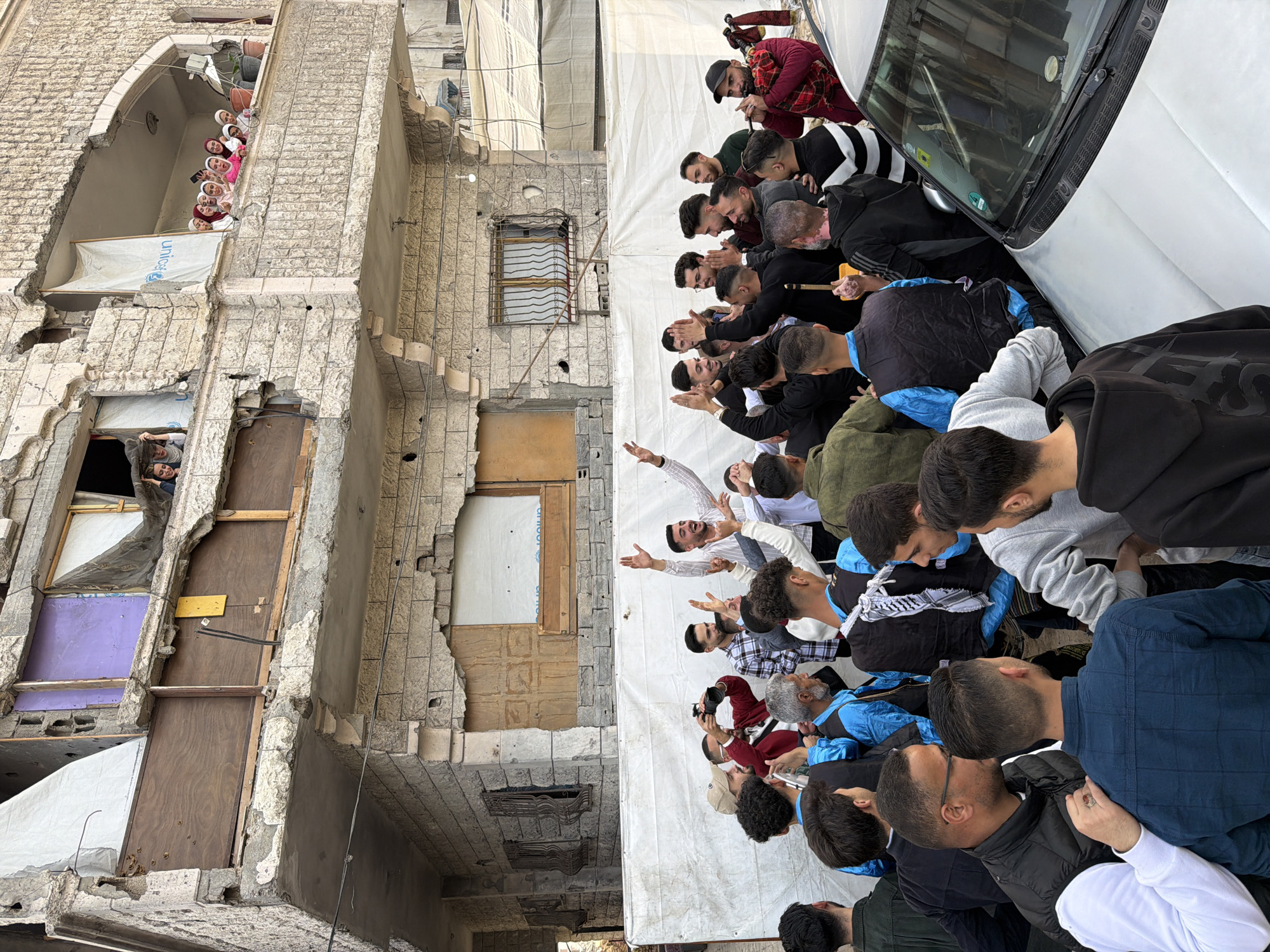 Thirty men gather around vehicle in Gaza City