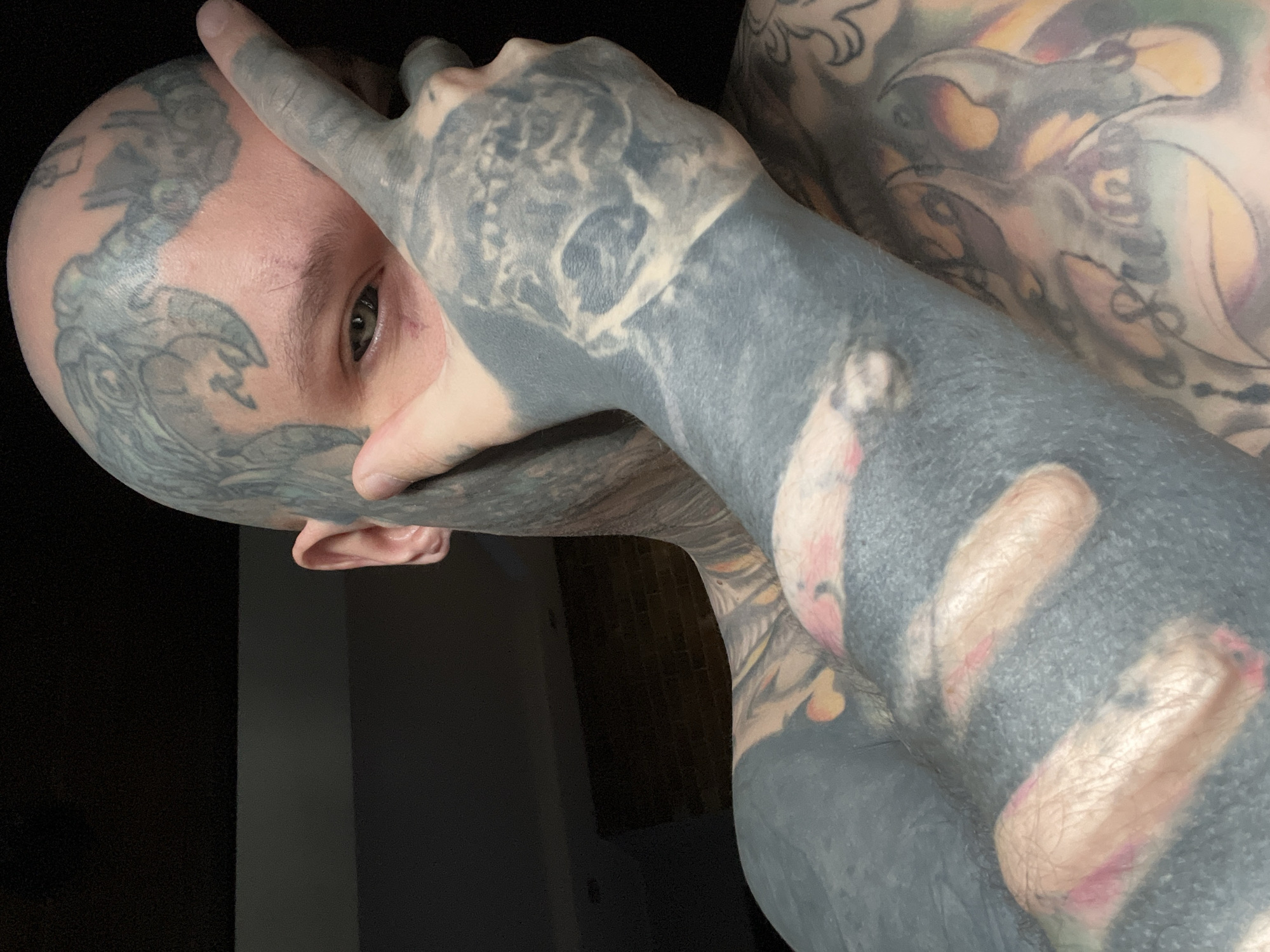 Heavily tattooed person photographed in Kudrovo, Russia