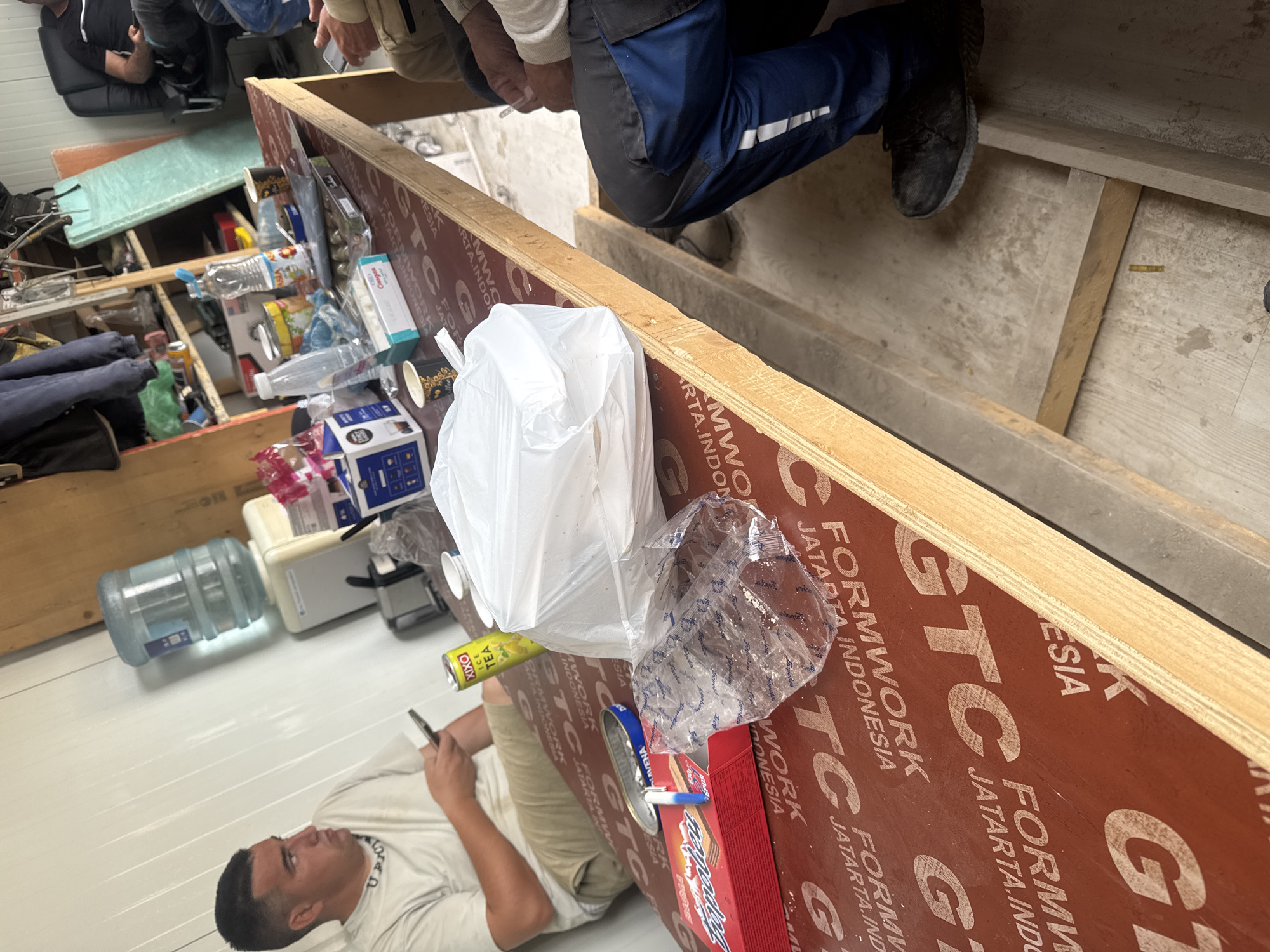Person uses phone in cluttered indoor space in Plovdiv