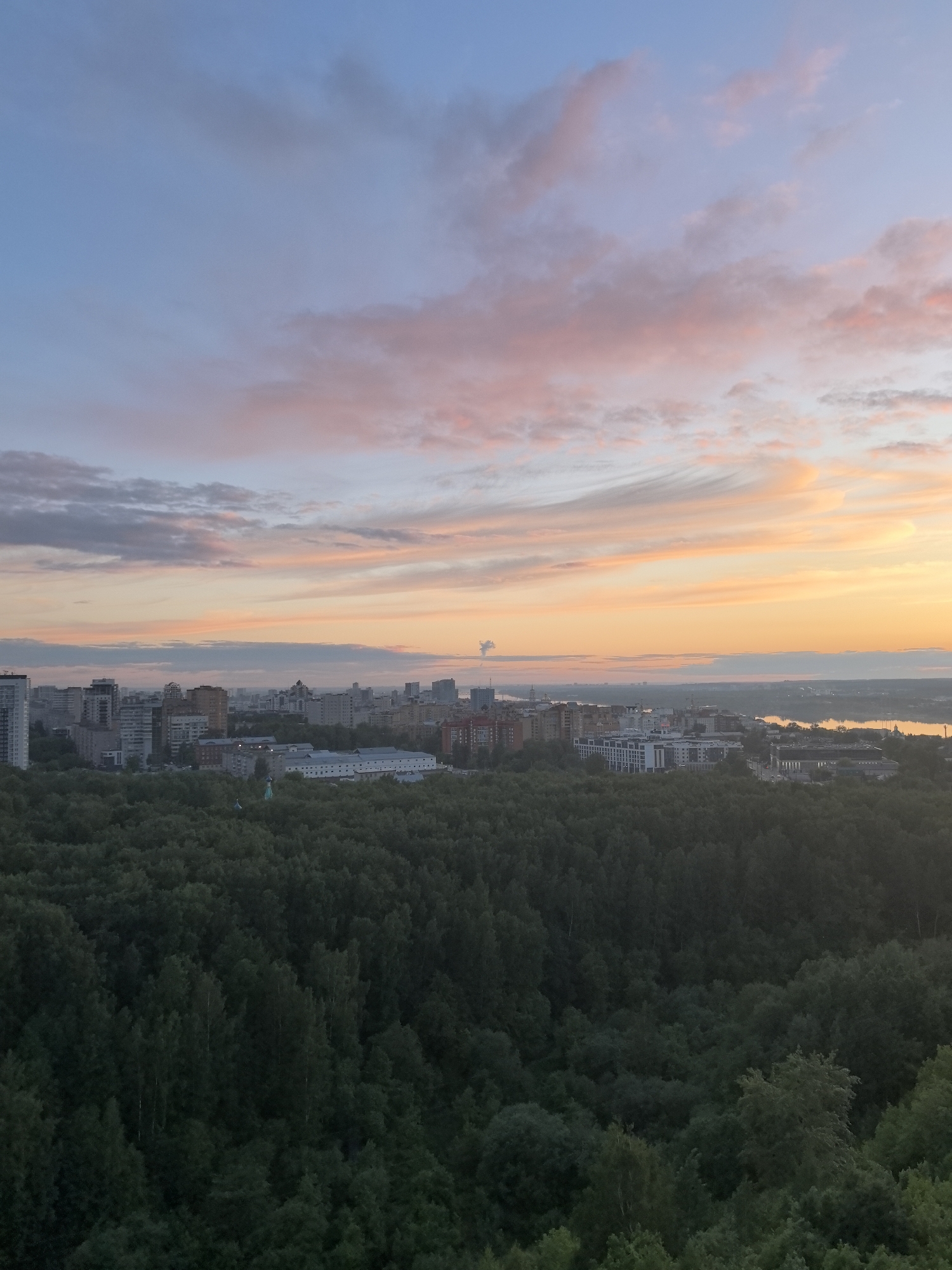 Sunset captured over Perm skyline from forested viewpoint