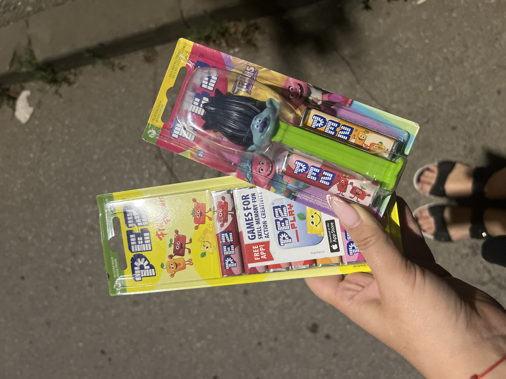 Person displays packaged PEZ dispensers on Sofia street