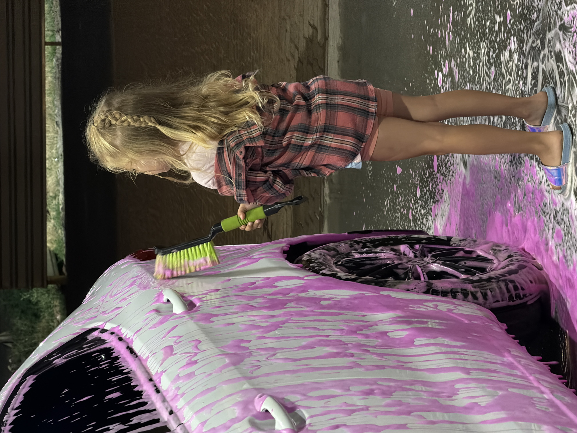White sedan gets a pink foam wash in Korsuntsi