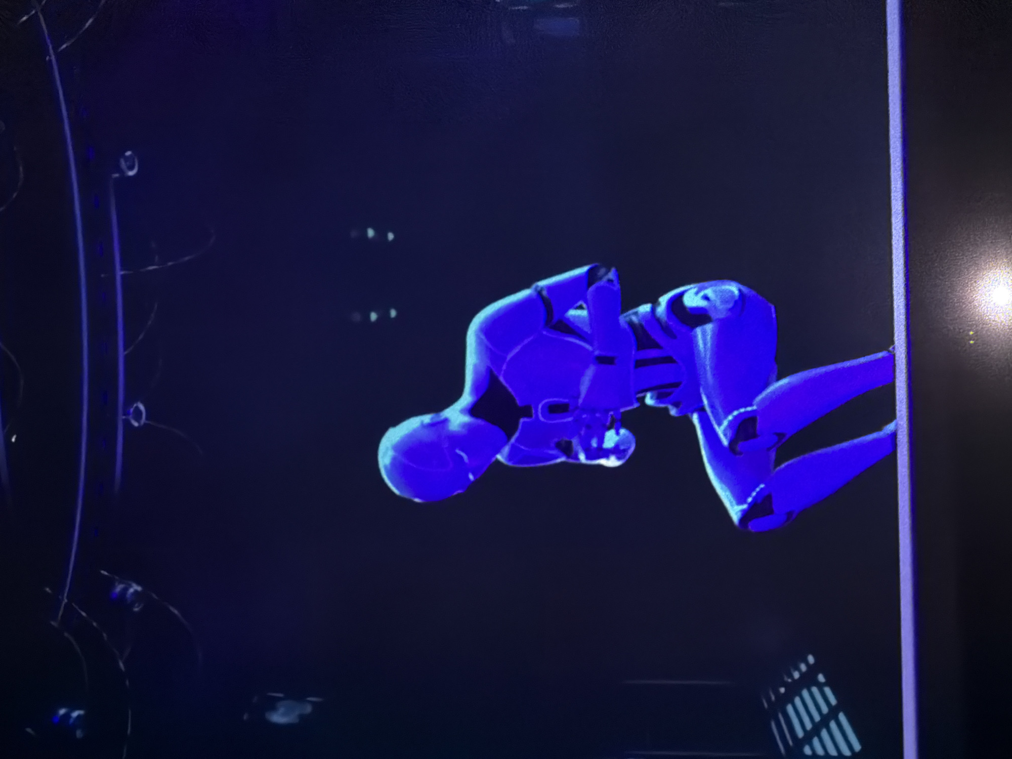 Immersive art exhibition blending holographic robots and glowing light installations