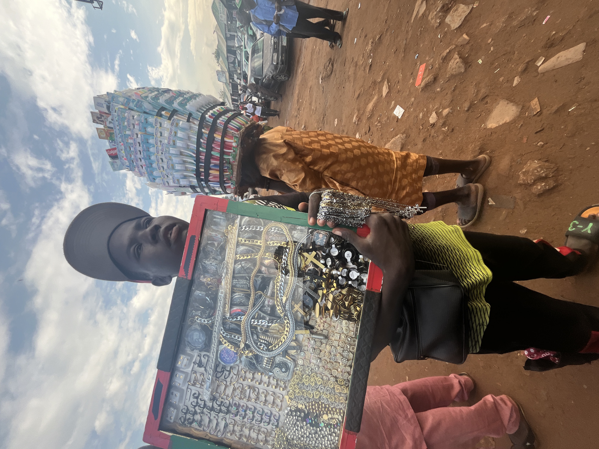 Street market hustle in Nyanya, Nigeria, with a glowing sidebar