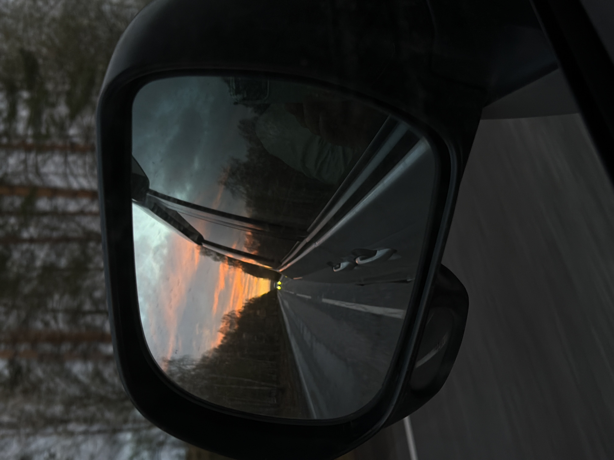 Evening drive captured in car mirror near Urten', Russia