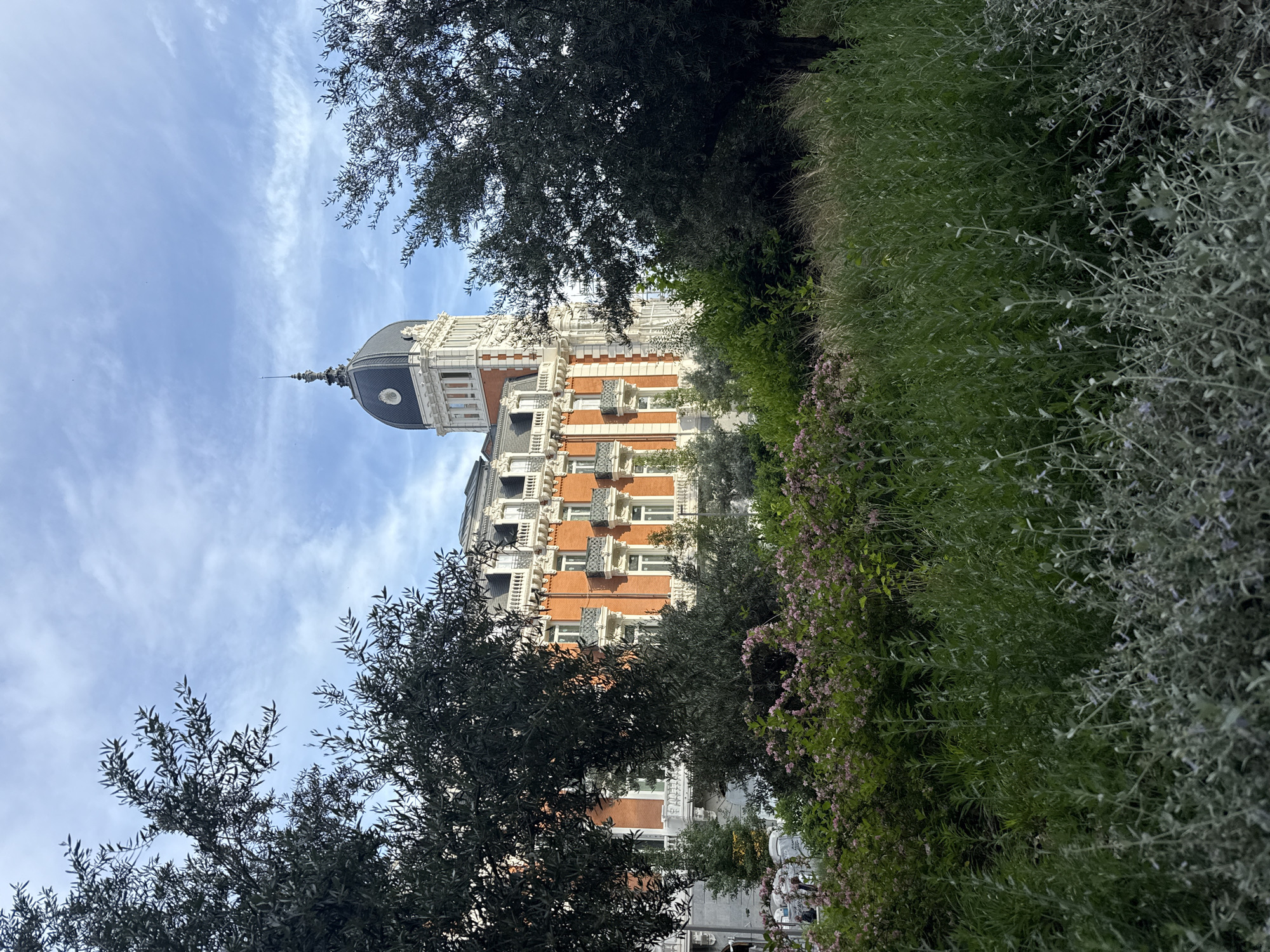 Tourist captures Madrid landmarks during afternoon walking tour