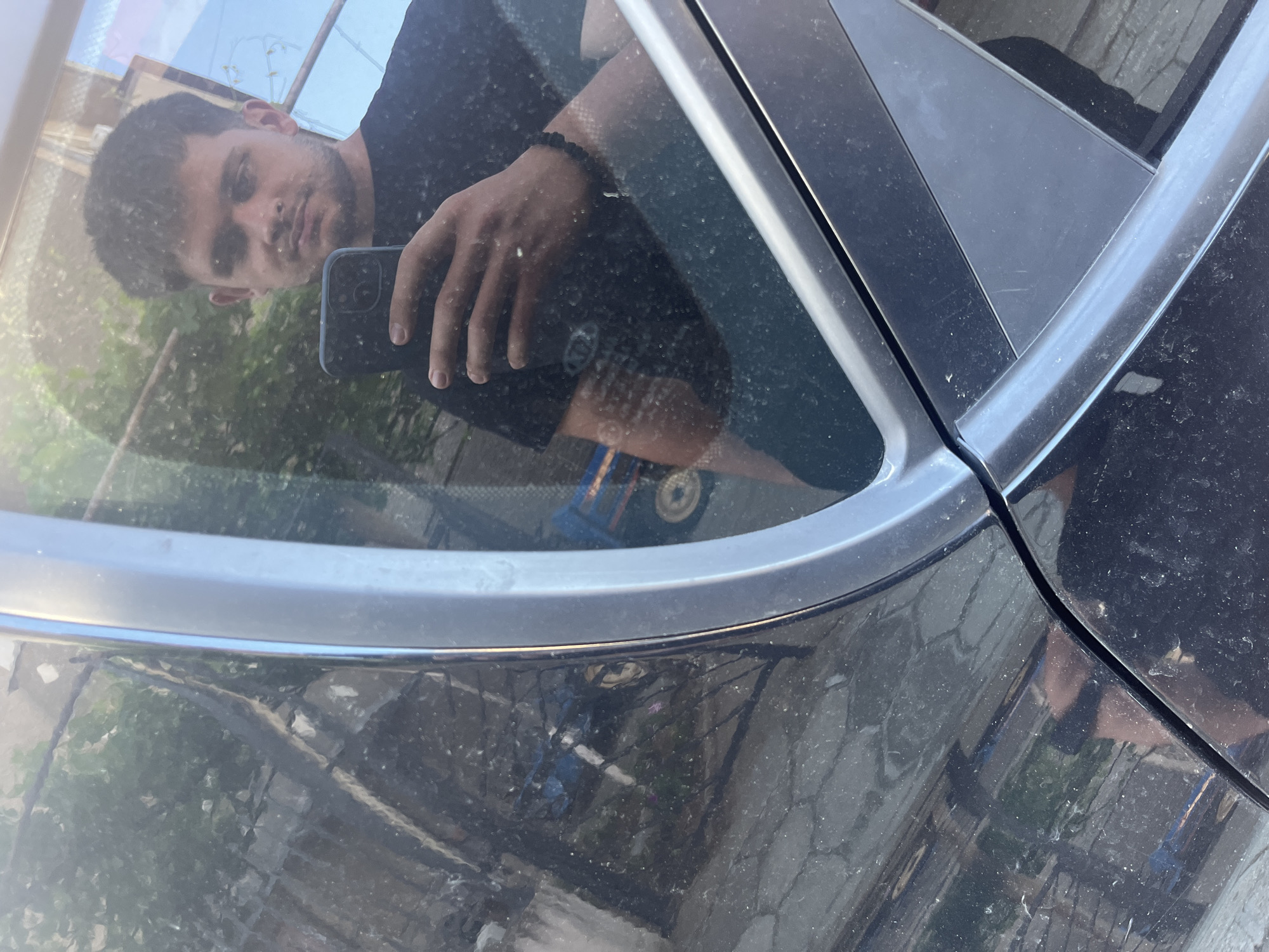 Car maintenance and romantic balloon display captured in Bulgarian village