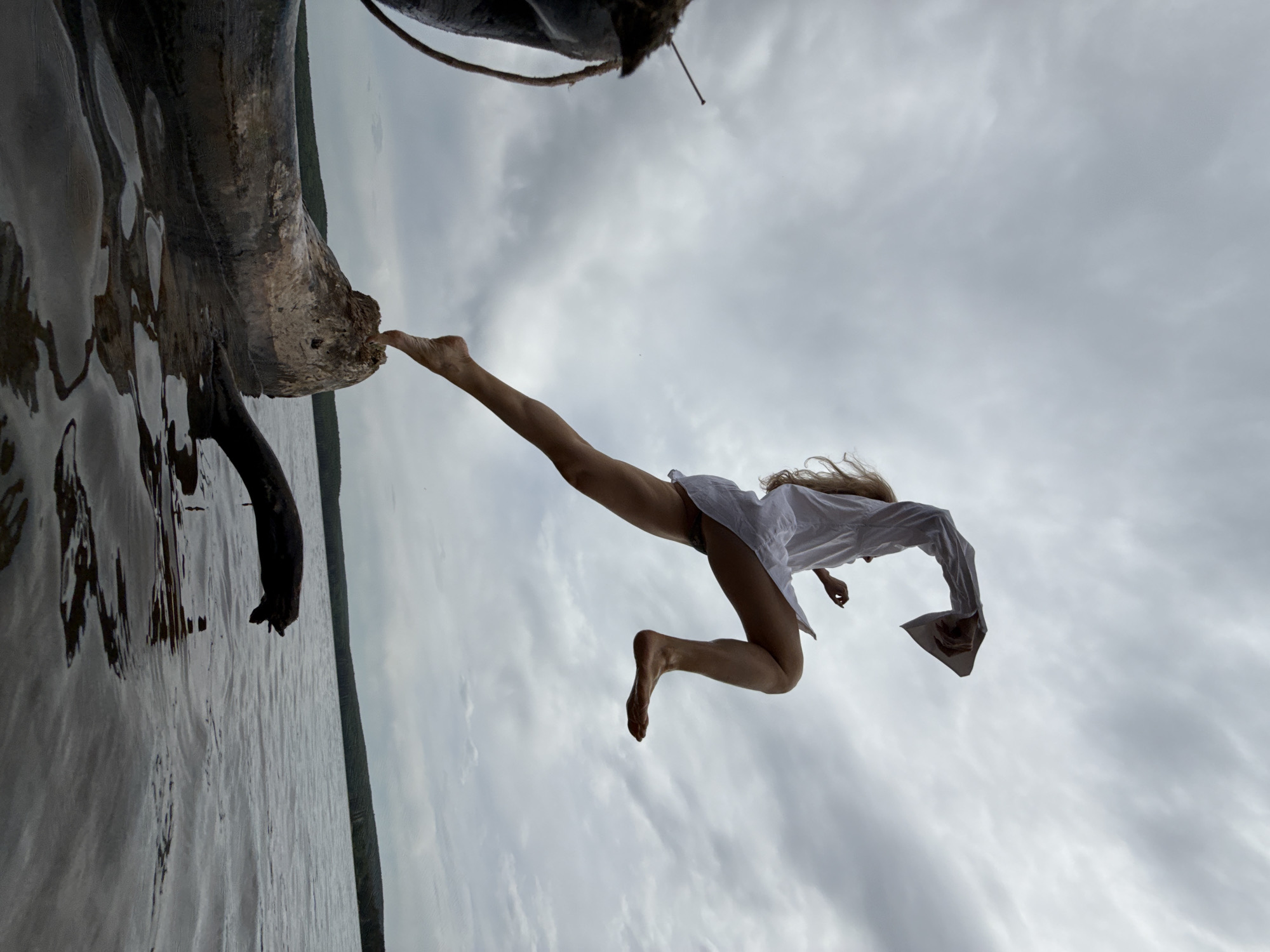 Woman photographed leaping from tree trunk in Chaikovsky, Russia