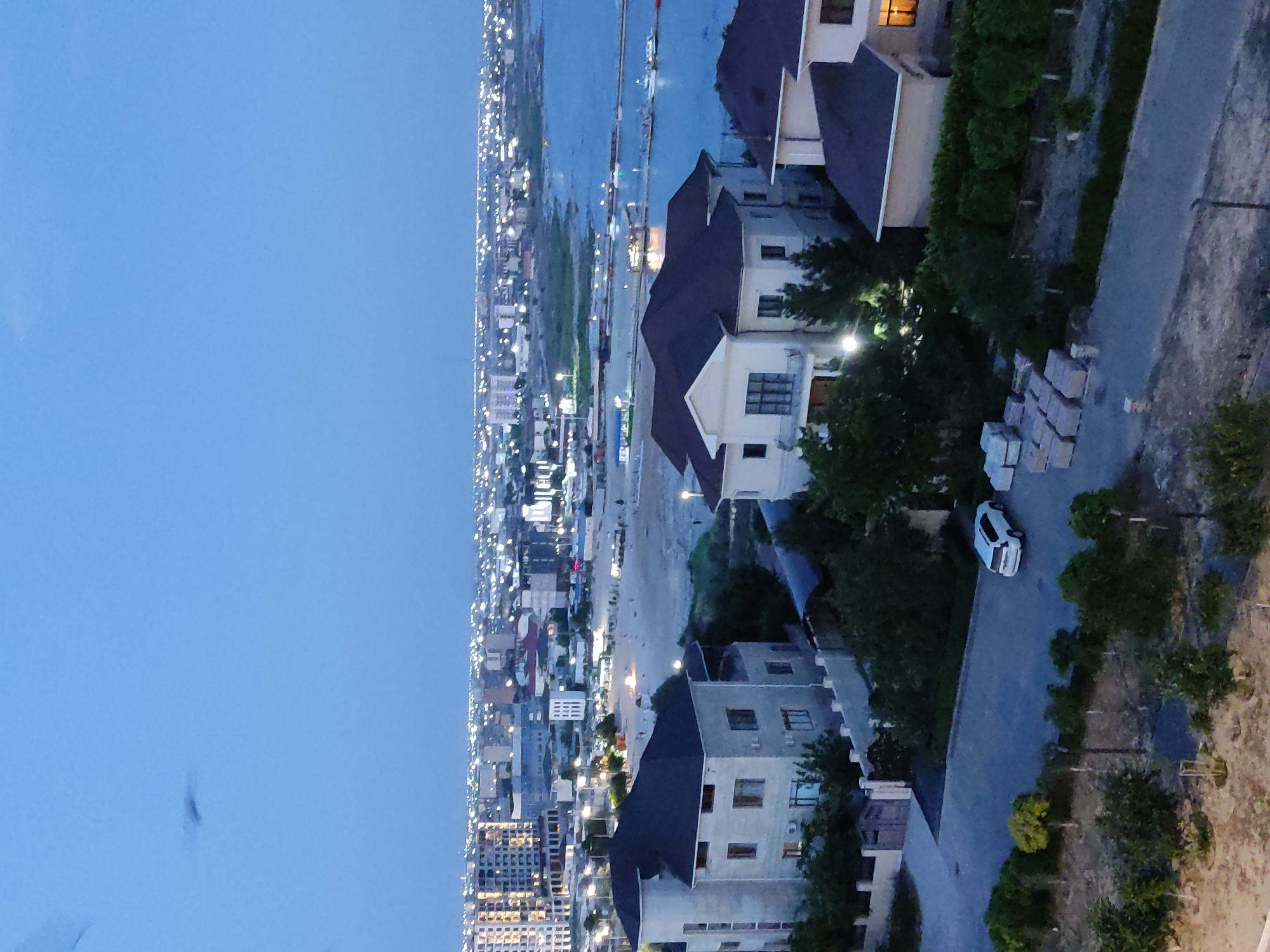 Aerial dusk views over a quiet coastal neighborhood
