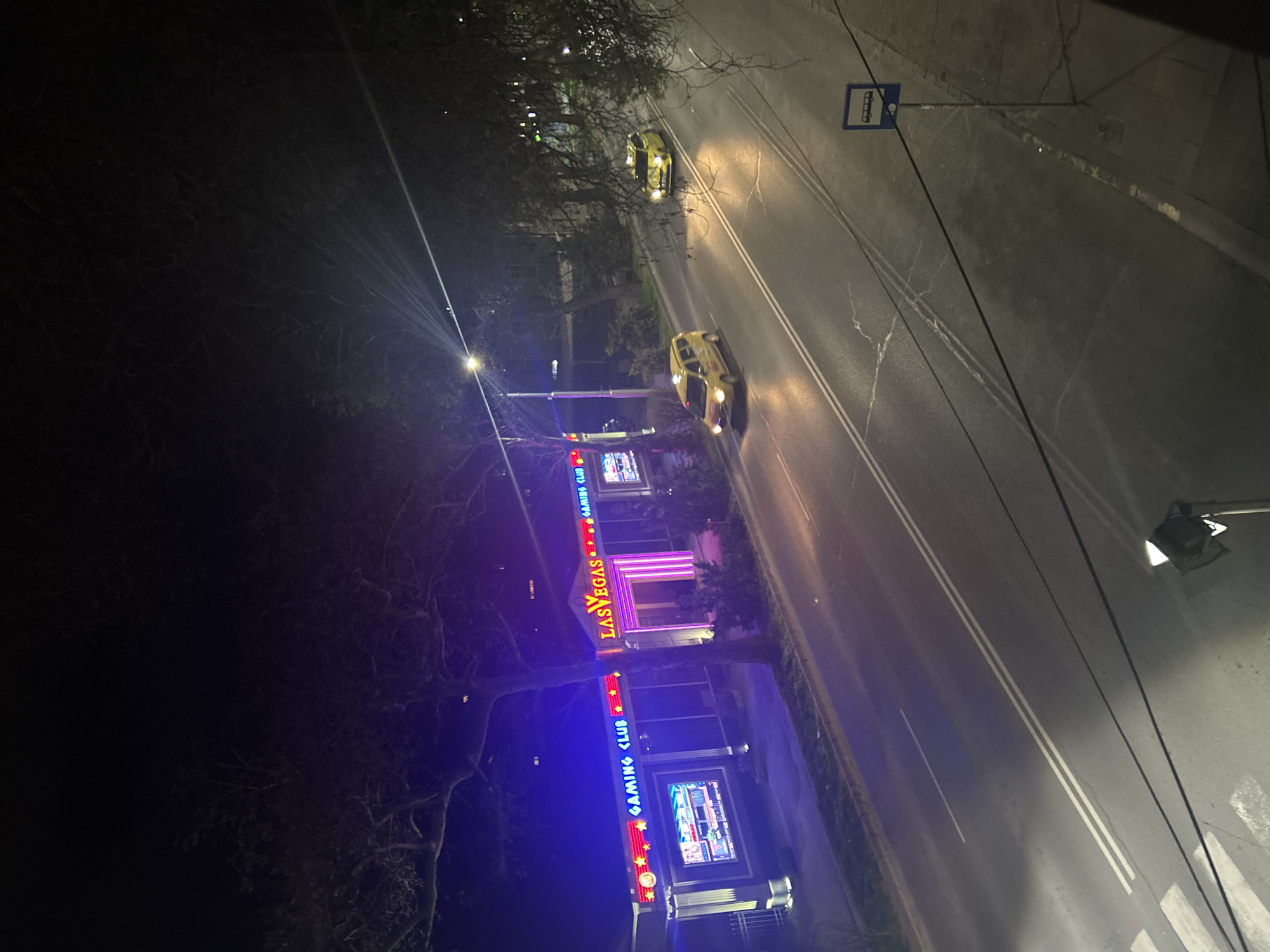 Nighttime street scene captured in Plovdiv featuring gaming club signage