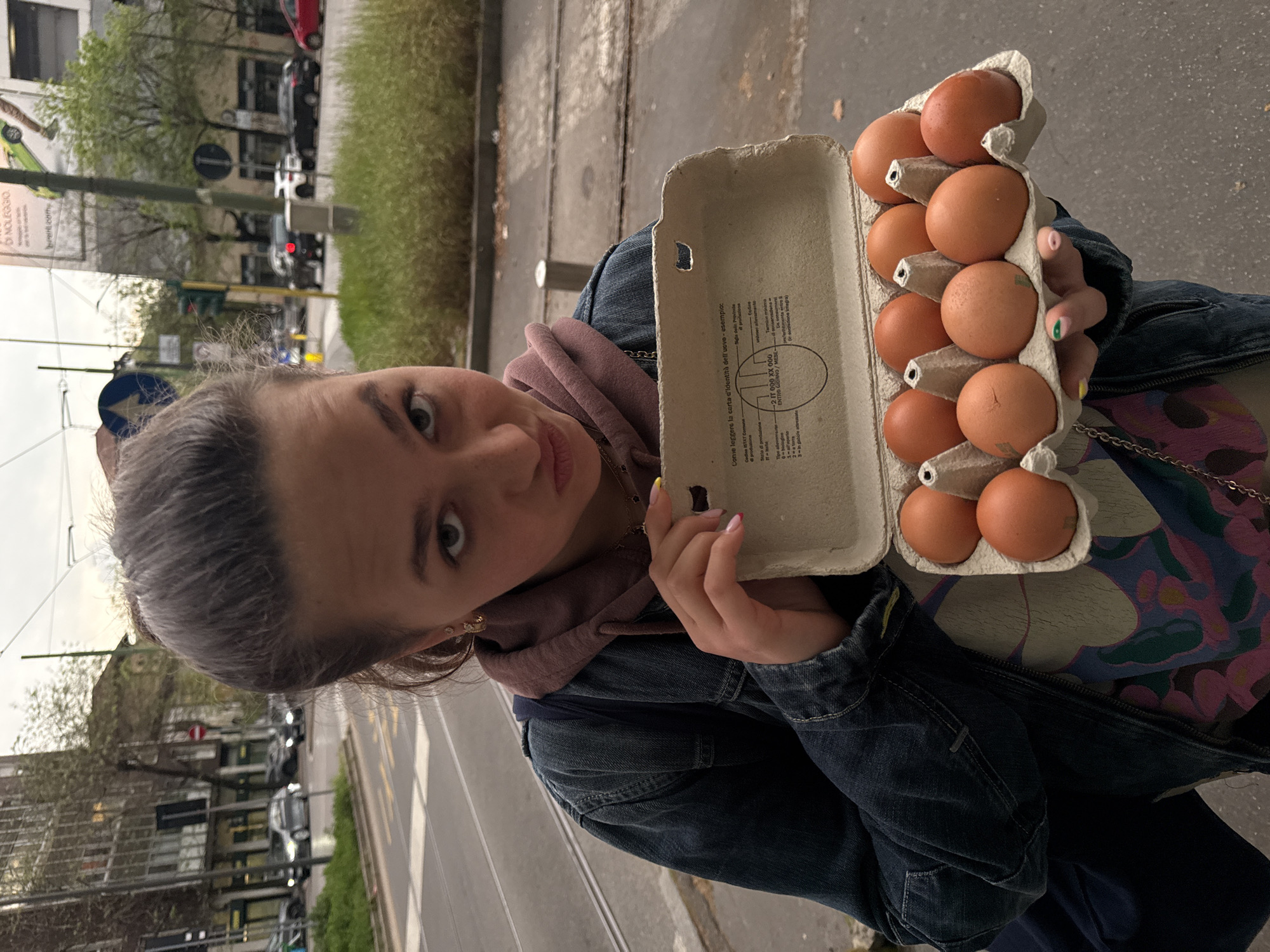 Woman holds egg carton in Milan street scene