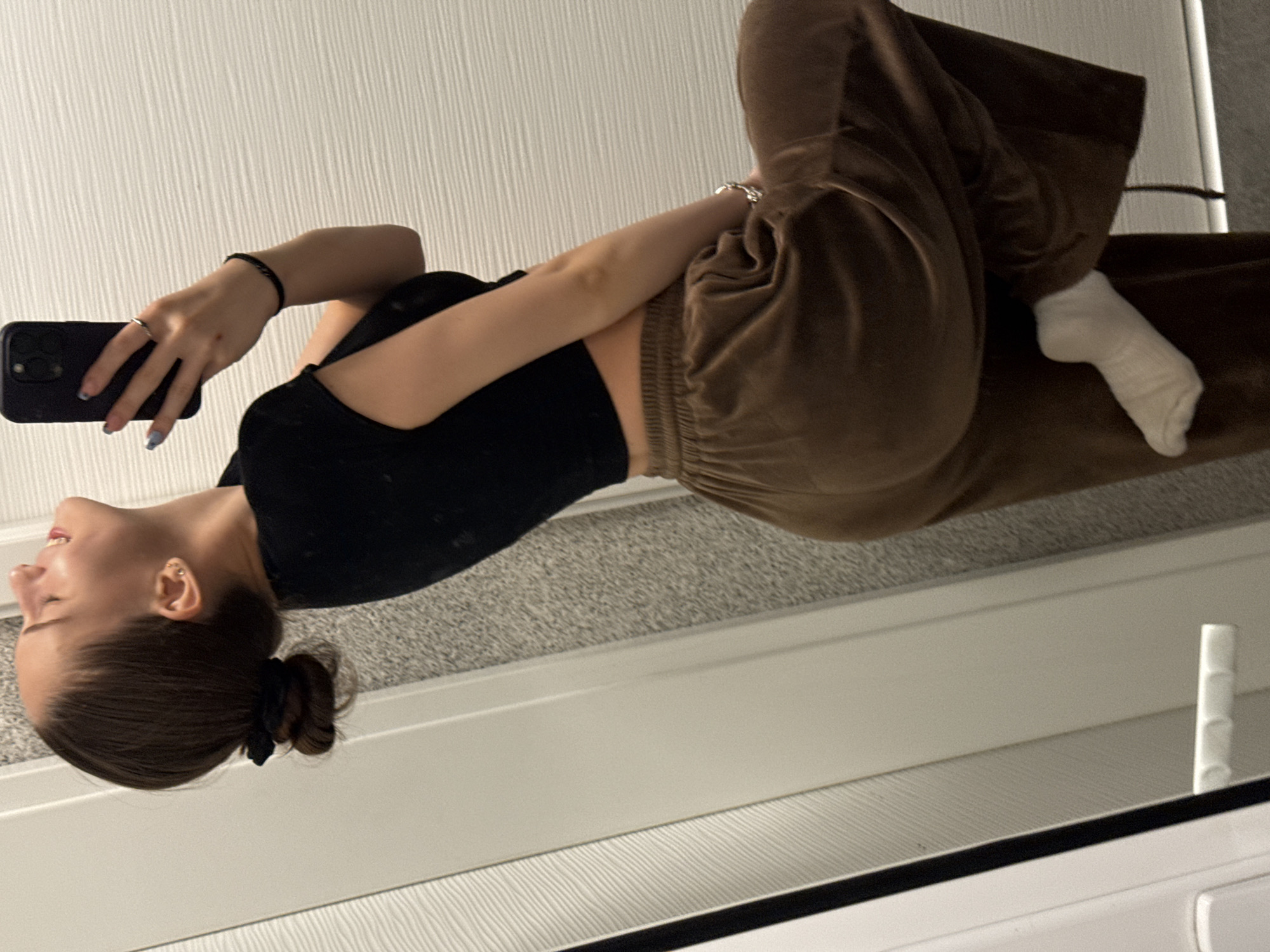 Woman takes bathroom mirror selfies in Sofia apartment