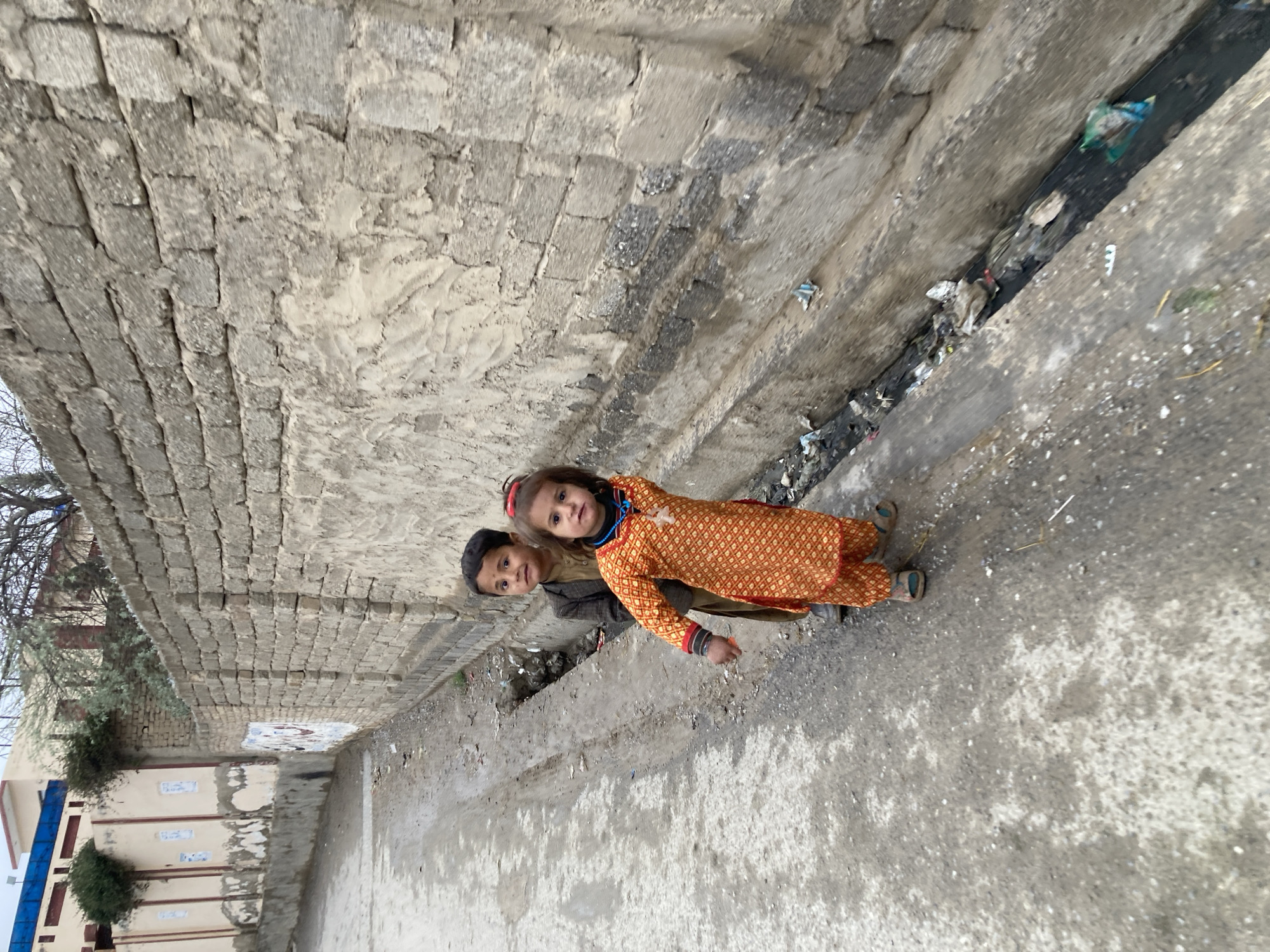 Two children pose for camera on Quetta street