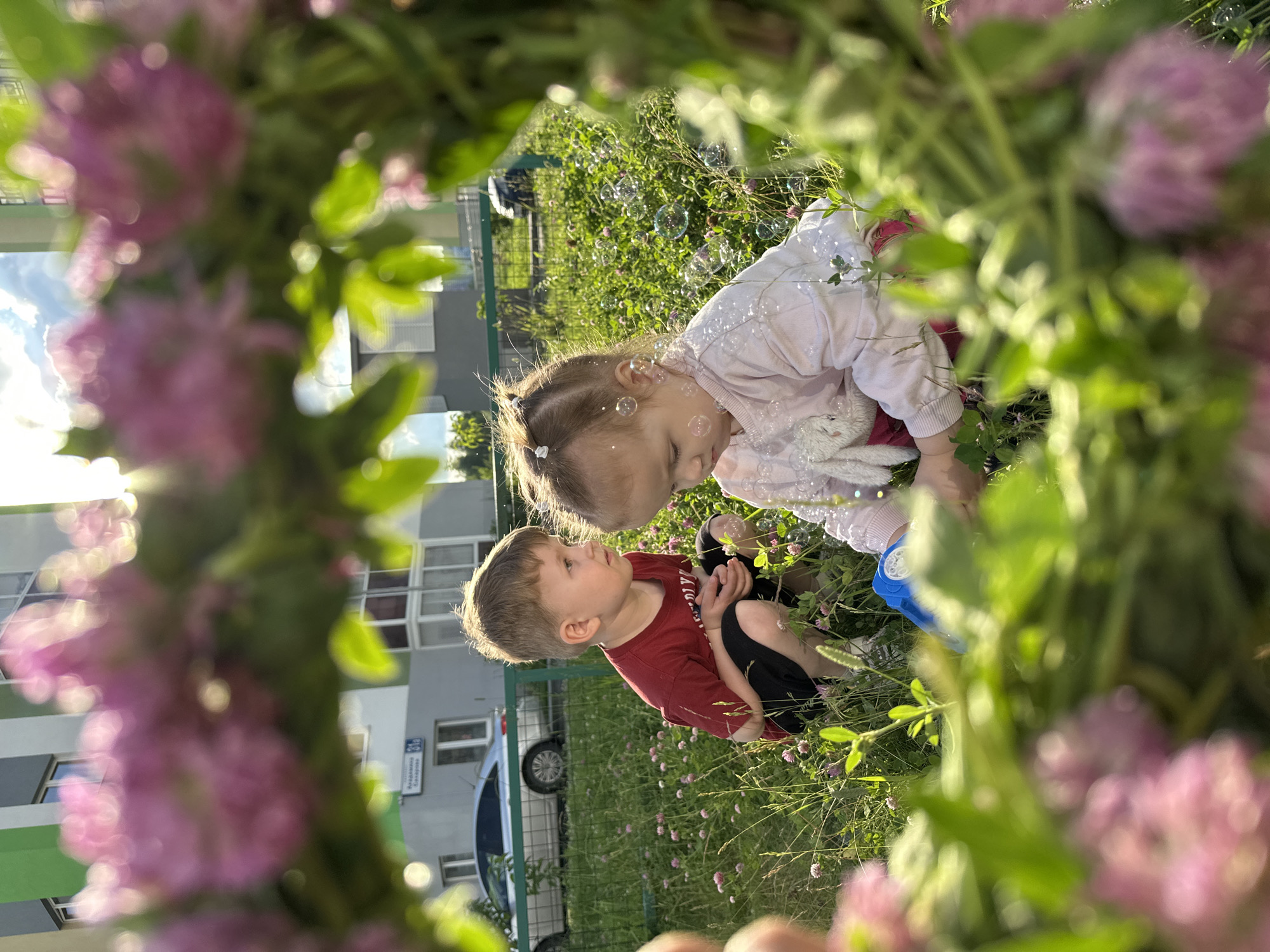 Kids, clover crowns, and sandbox play on a Yekaterinburg summer afternoon