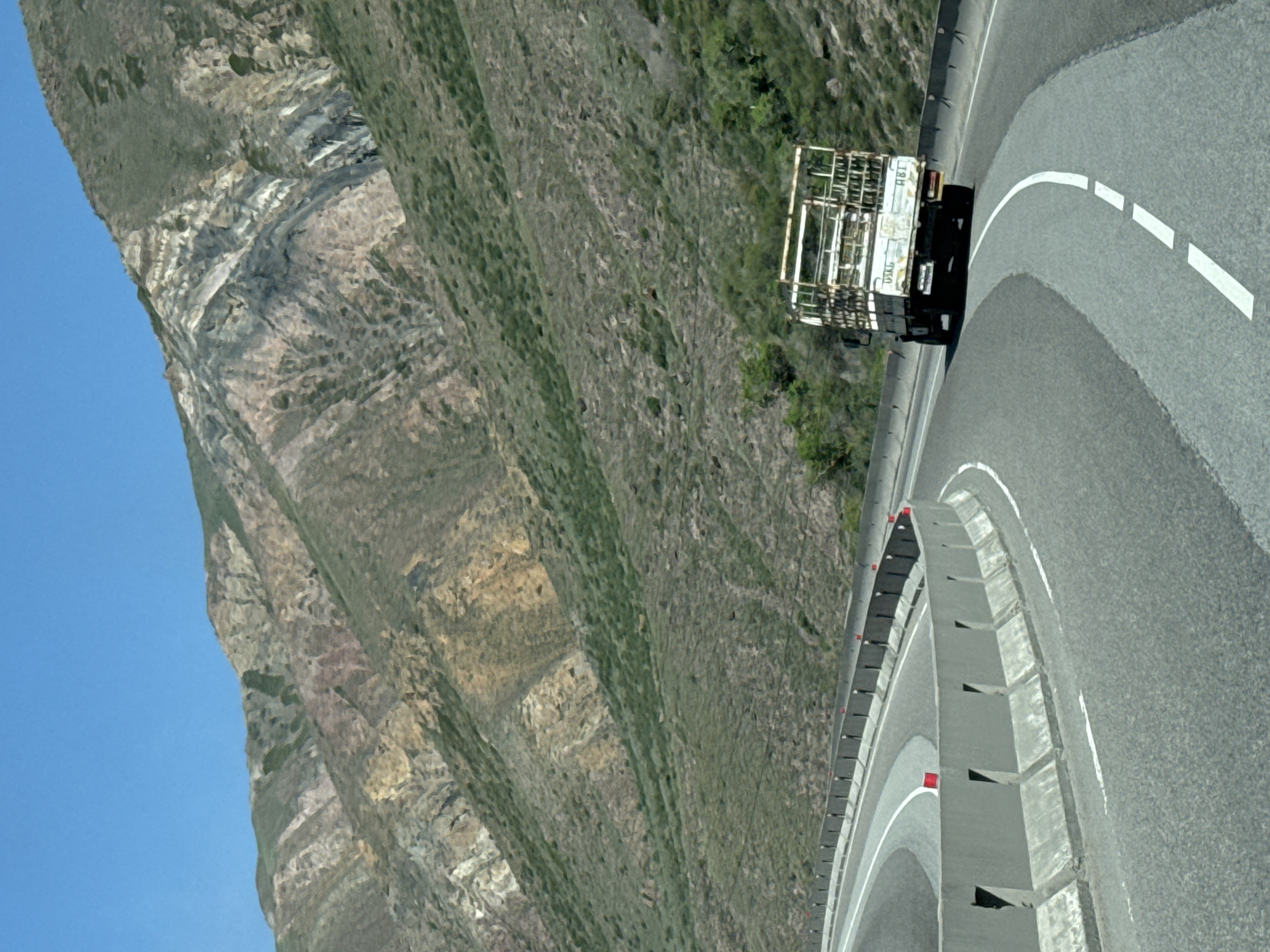 Truck spotted on curved road in Krasnyy Most, Kyrgyzstan