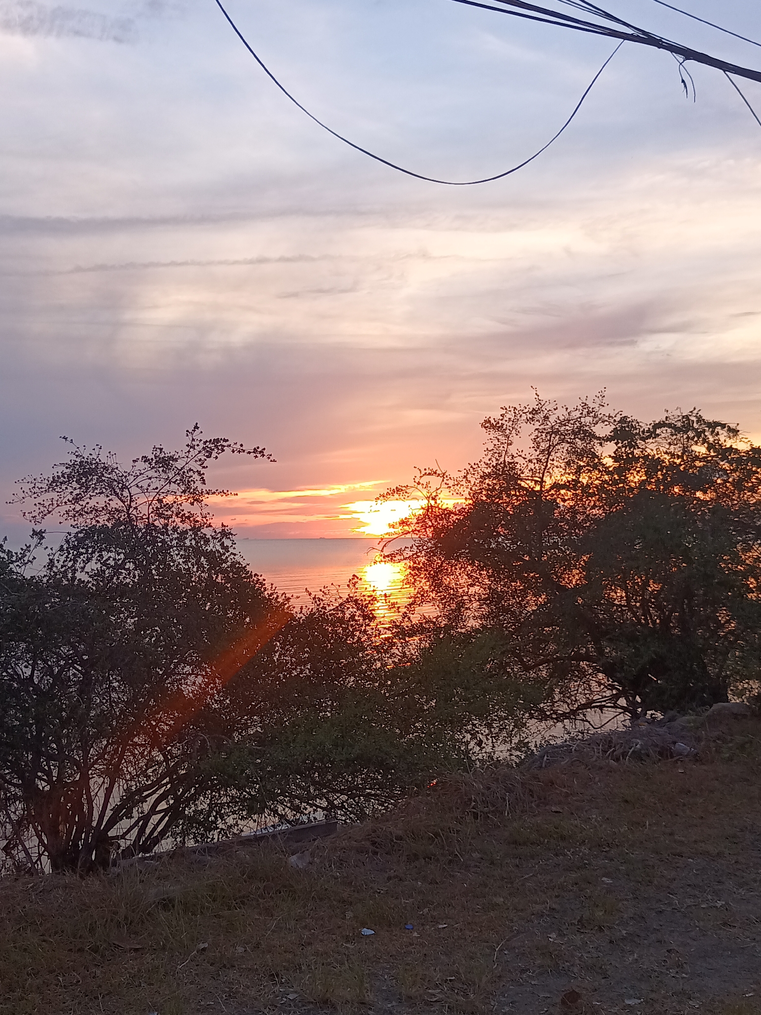 Sunset photographed over water at Baan Sri Thanu, Thailand