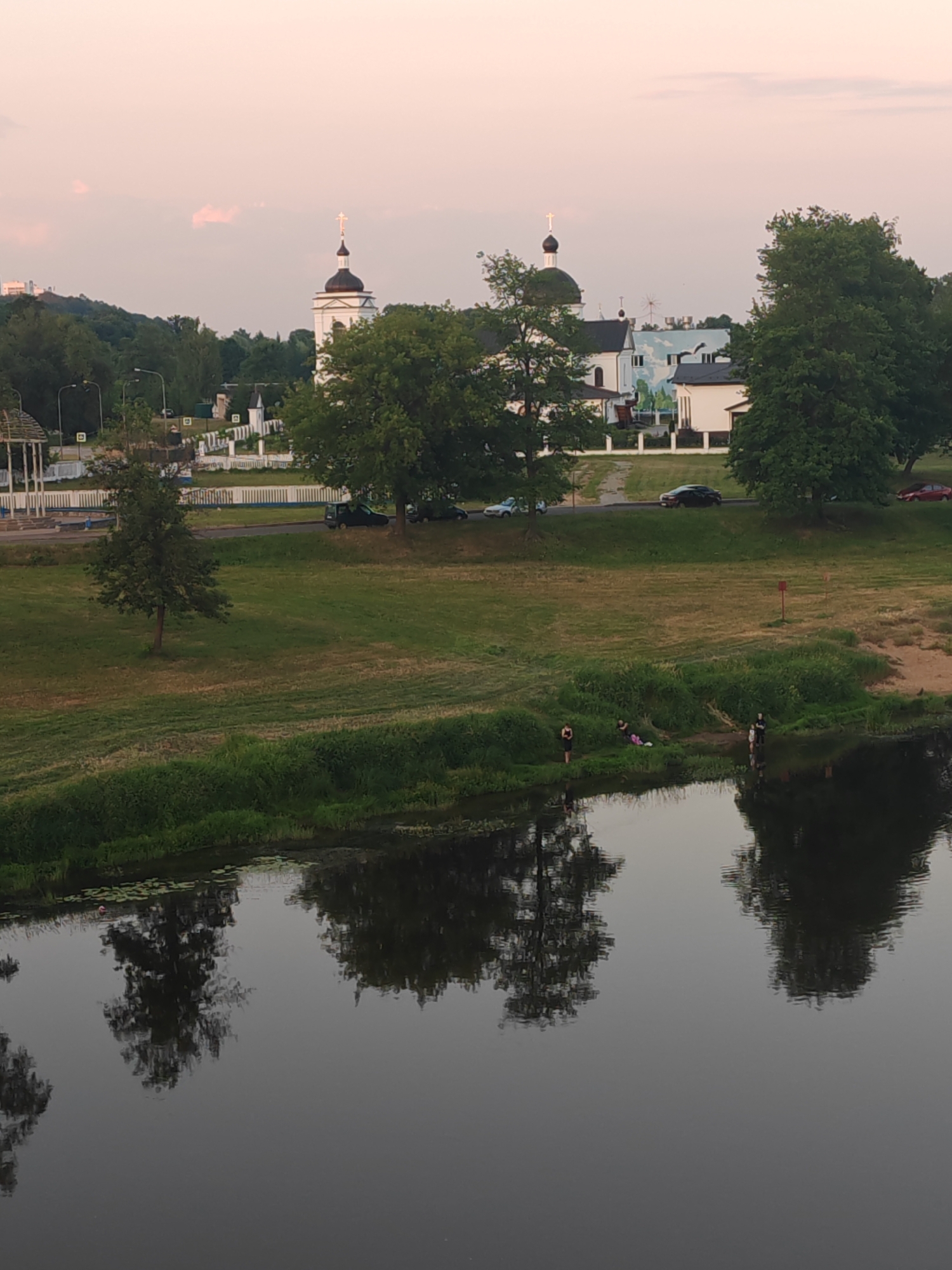 Sunset along the Mahilyow riverfront, flags and monuments in view