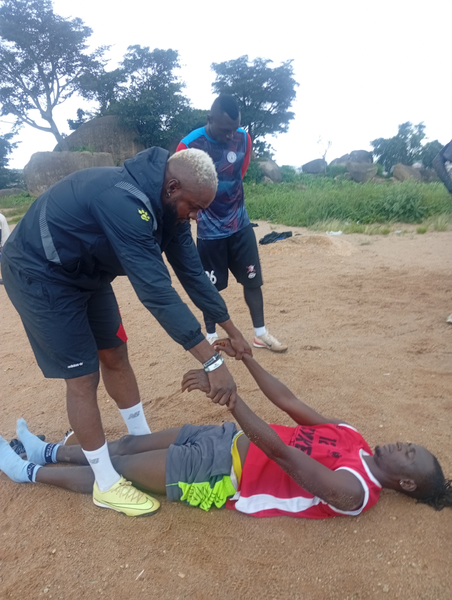 Football training session on a dusty Jos field