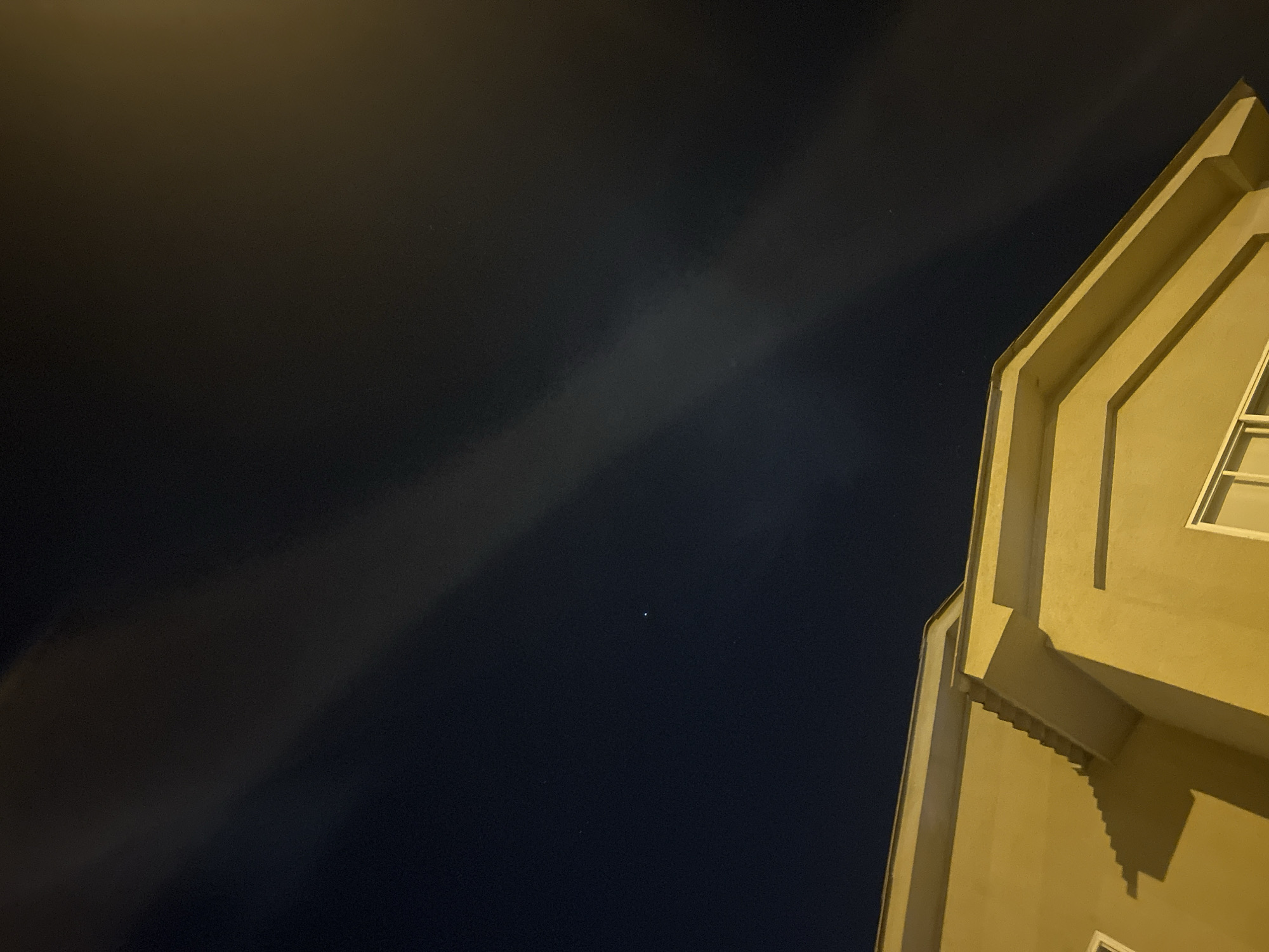 Nighttime building exterior captured under cloudy sky in Ecuador