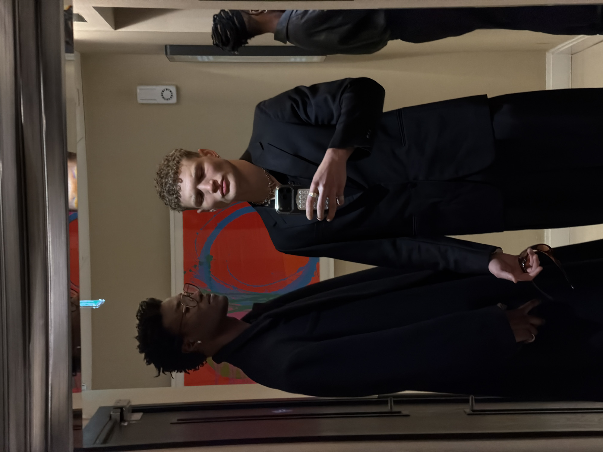 Three men take mirror selfies in London building