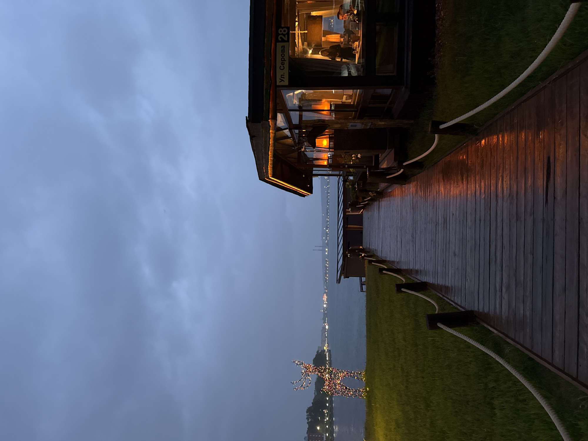 Evening waterfront scenes documented at Votkinsk restaurant terrace area