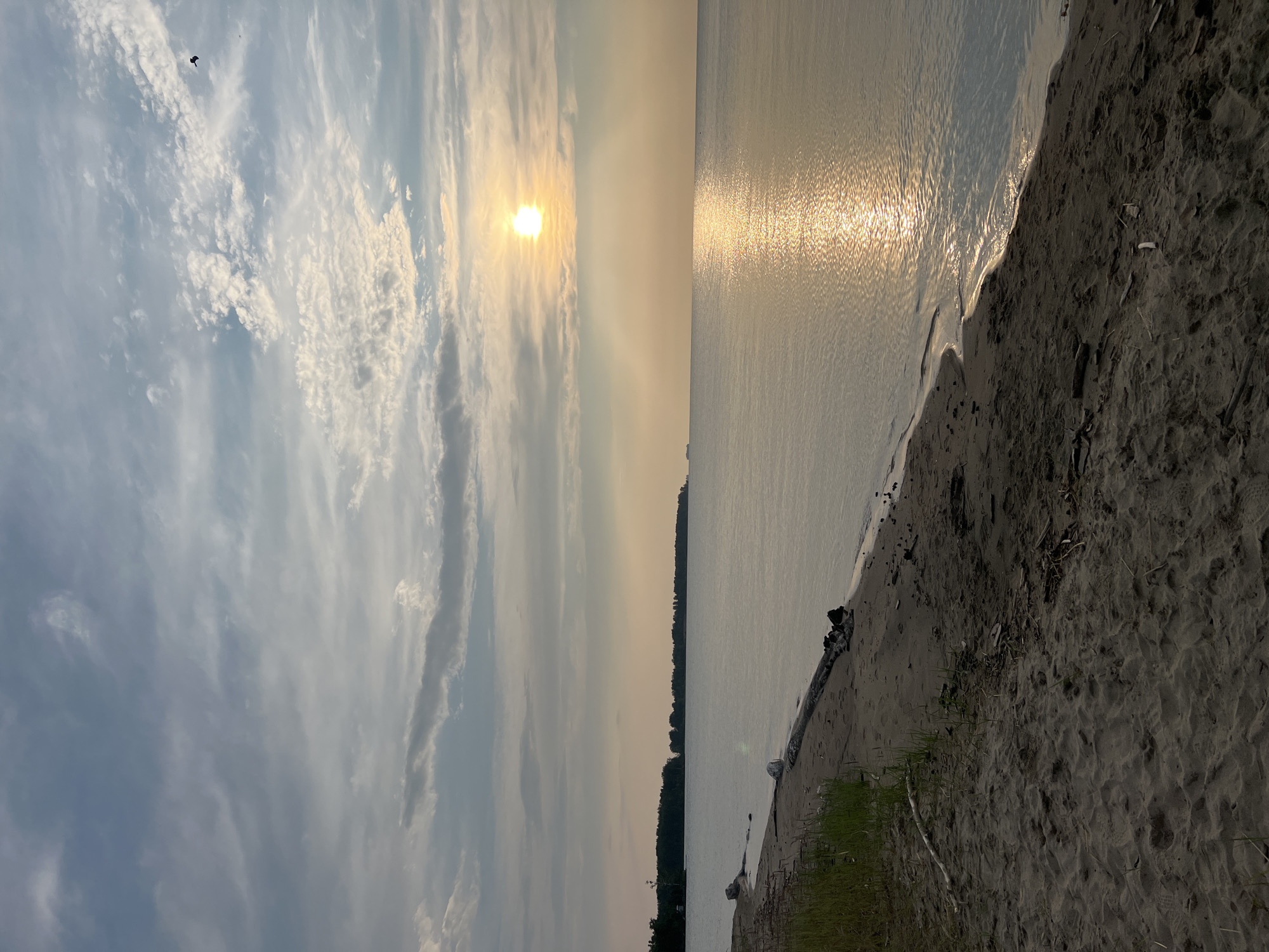 Calm sunset evening on the Borovoe shoreline with moored inflatables