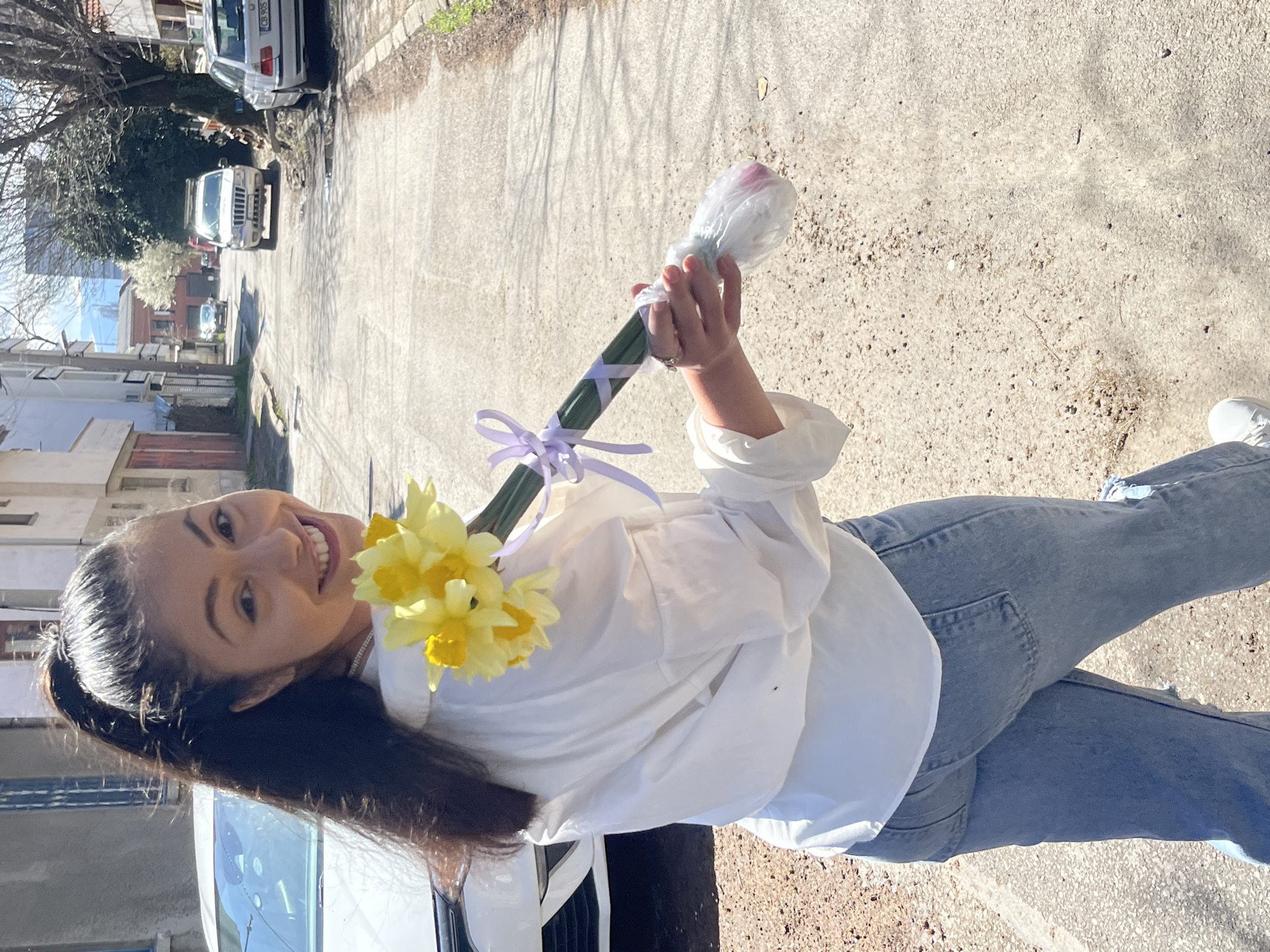 Young woman holds flower bouquet on Sofia street