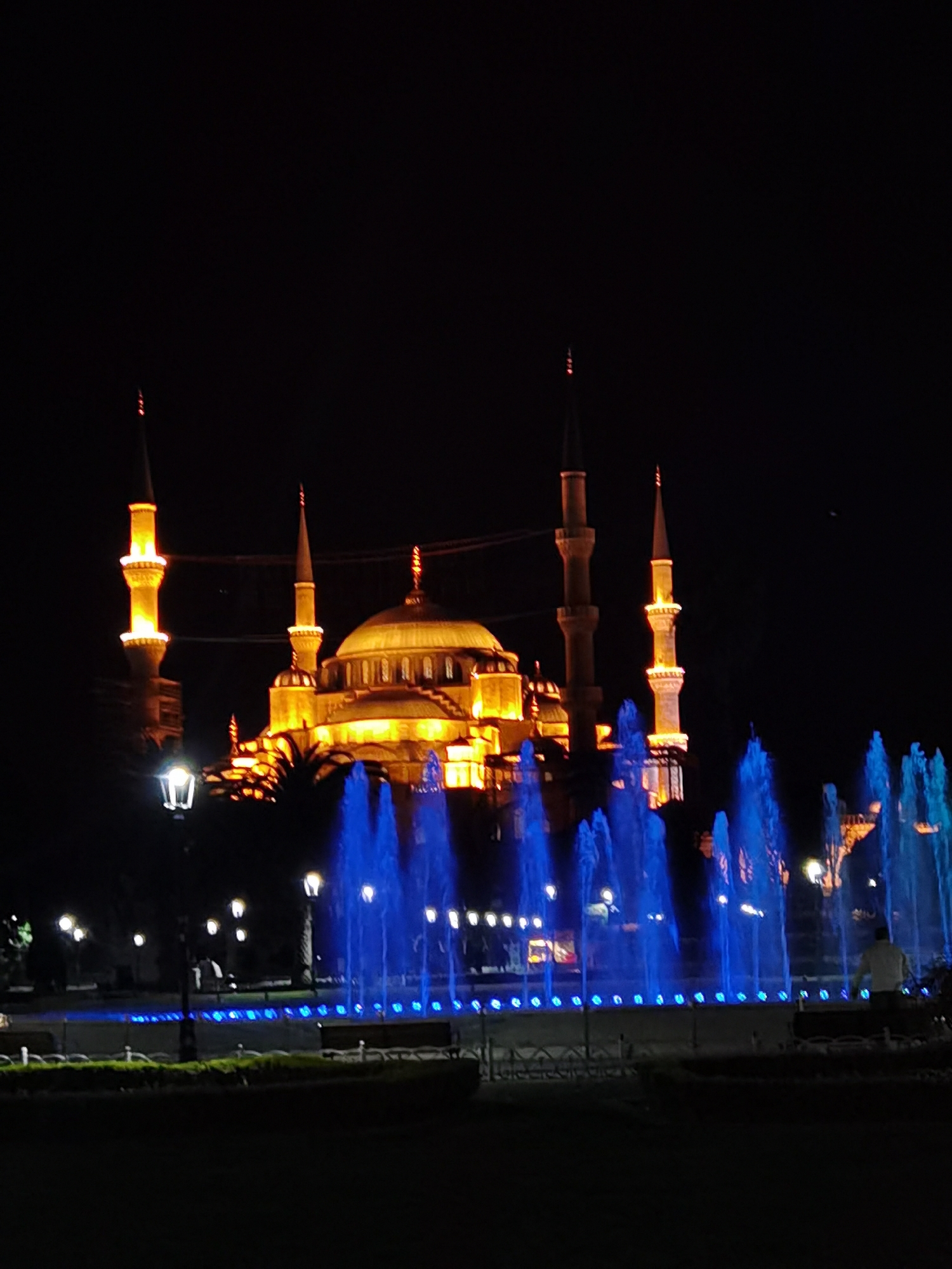 Evening tourist documentation of illuminated Blue Mosque and Sultanahmet landmarks