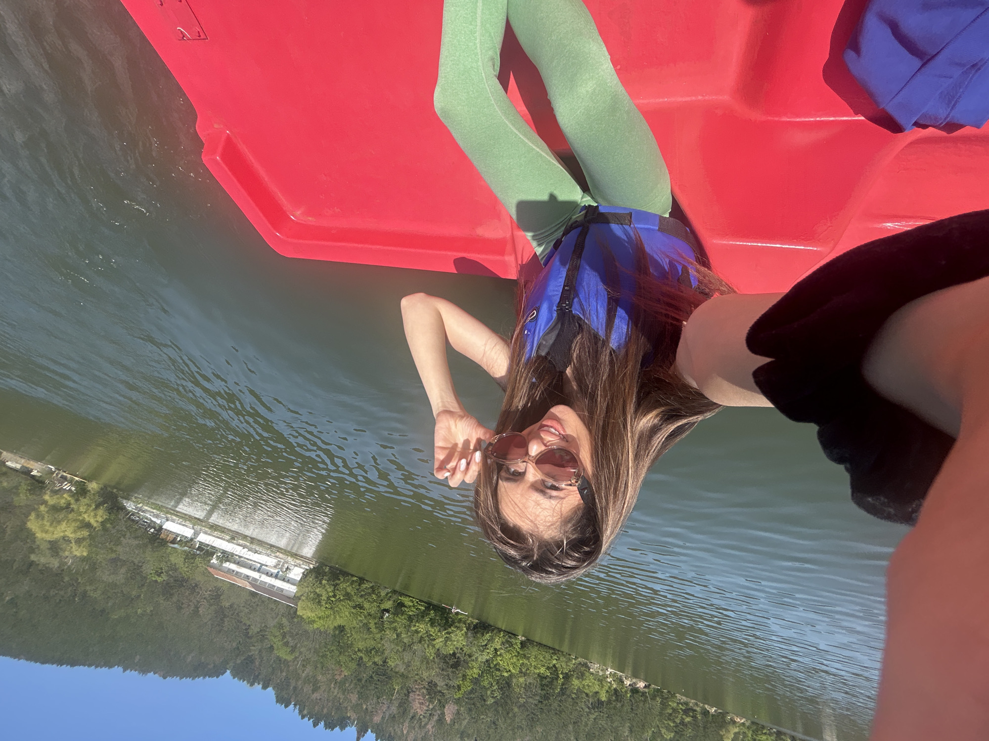 Woman takes selfie in red paddle boat on Bulgarian lake