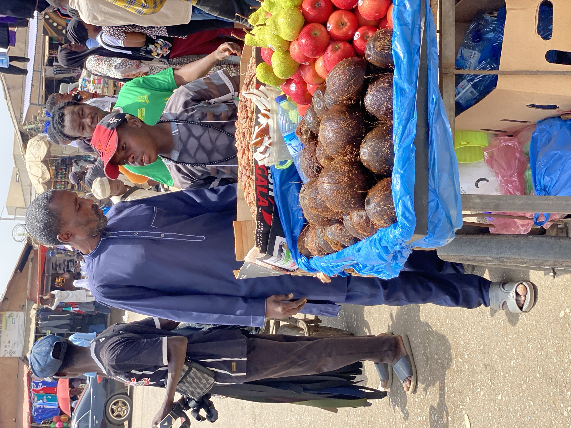 Street vendor operates fruit and water cart in Maiburiji