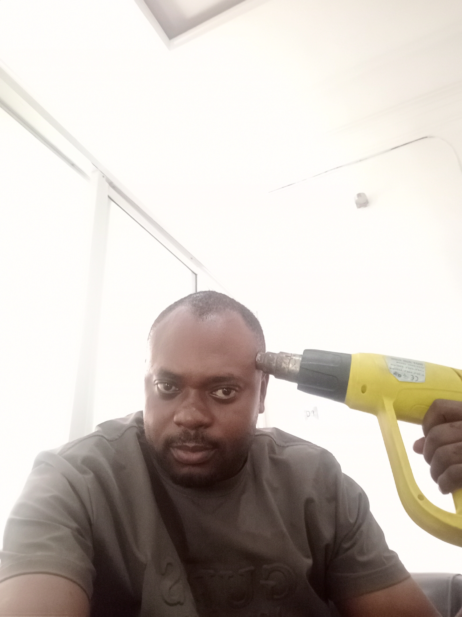 Man photographed in multiple indoor poses in Gwarinpa, Nigeria