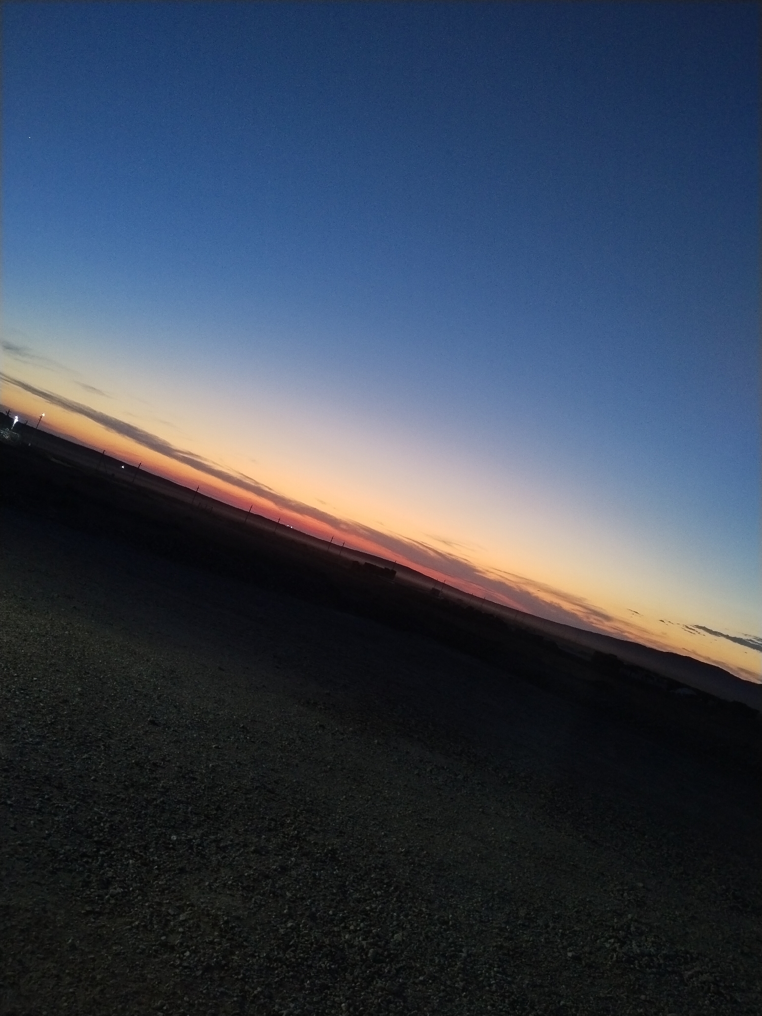 Dusk settles over an empty steppe road in rural Kazakhstan