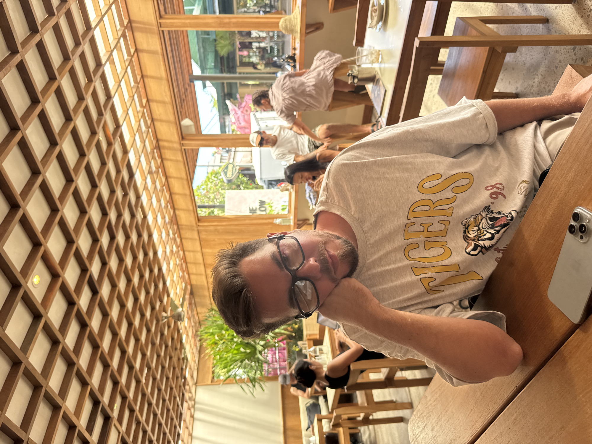 Man with glasses spotted dining at lattice-ceiling restaurant