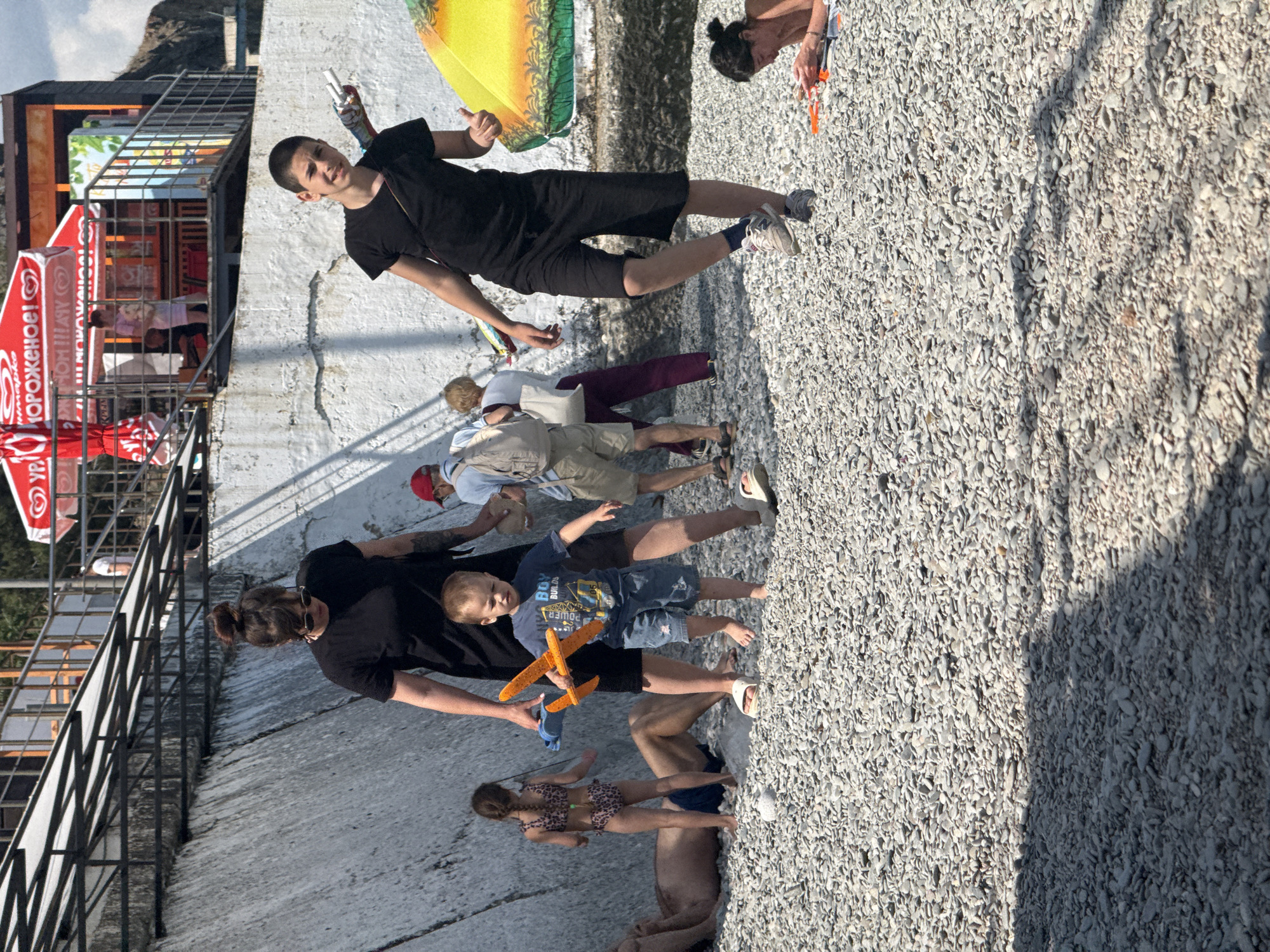 Families enjoy sunny afternoon at pebble beach
