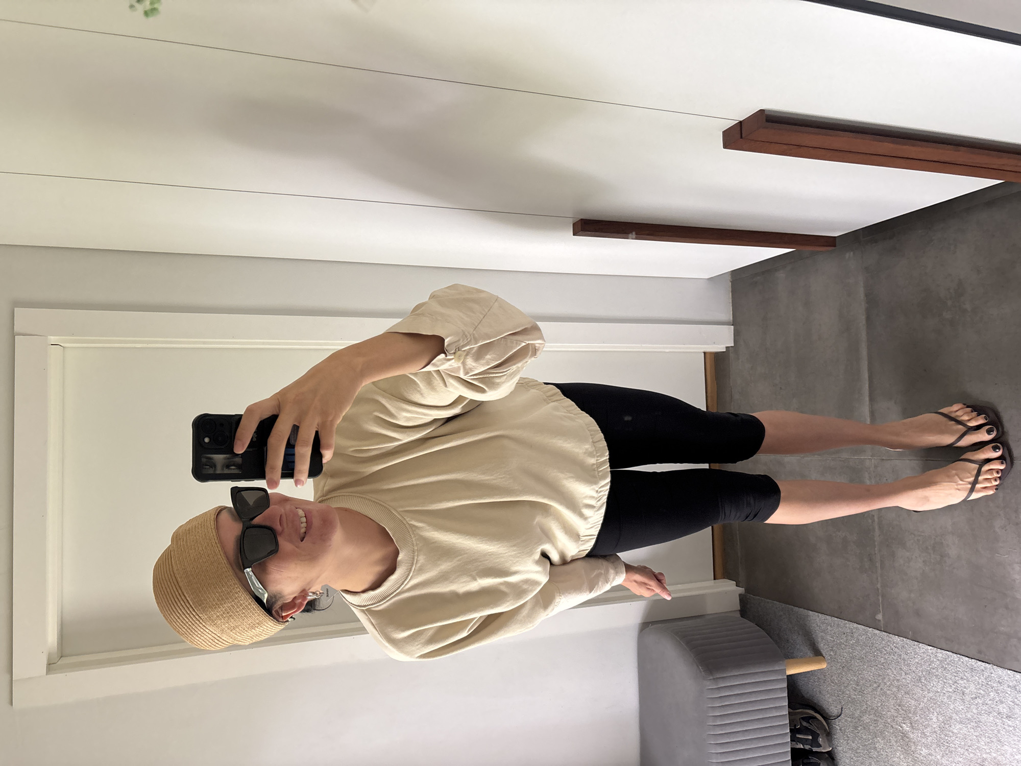 Woman takes mirror selfies with child in Chaikovsky home