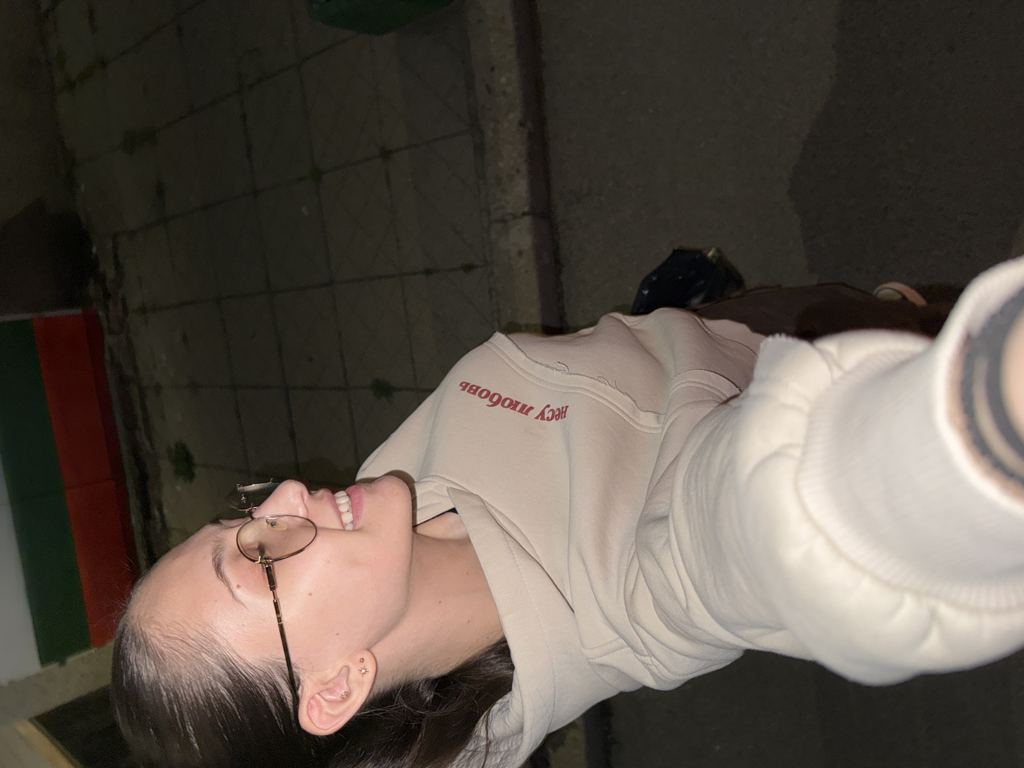 Woman takes nighttime selfie while walking Sofia streets