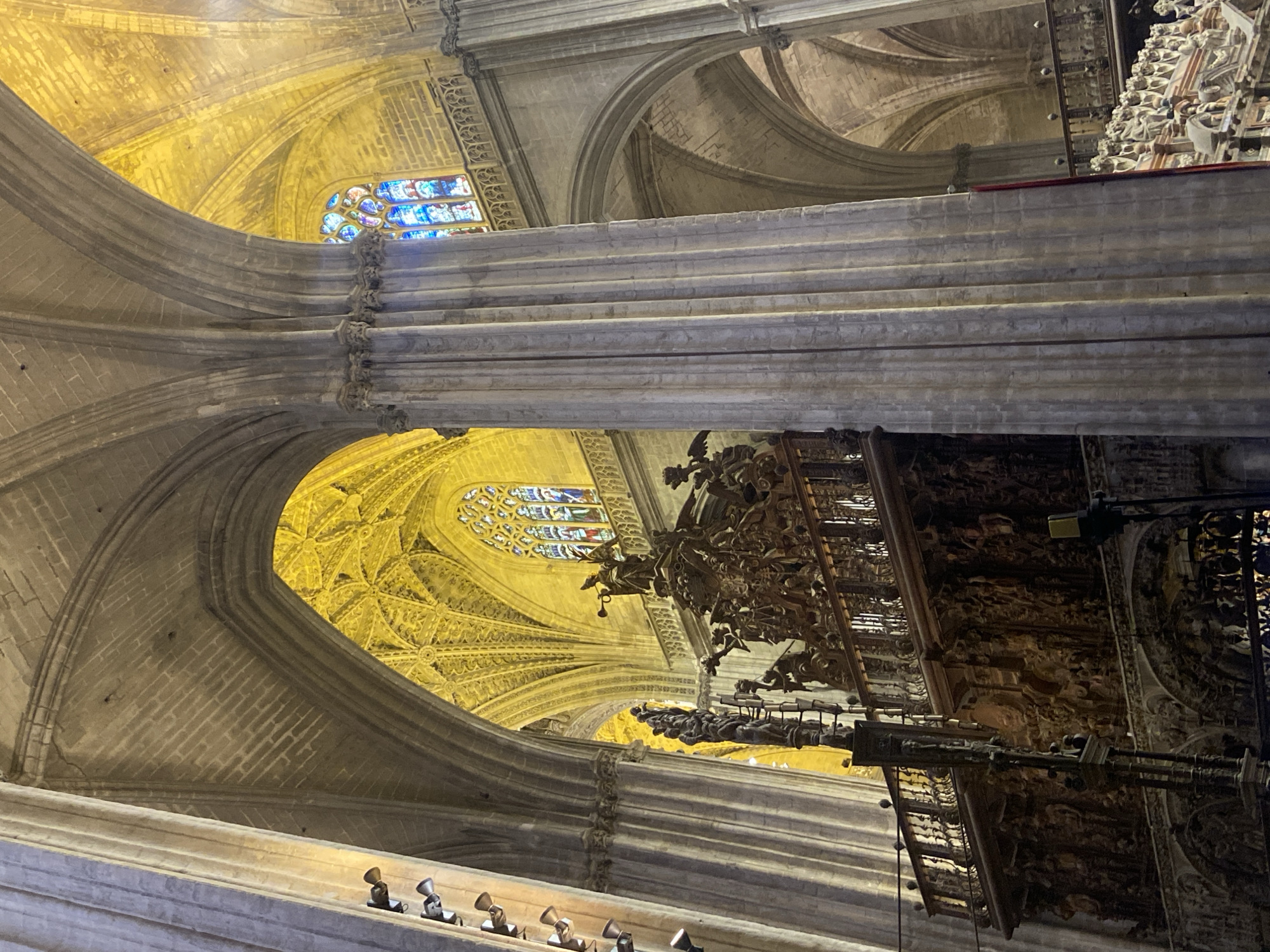 Visitor photographs Seville Cathedral's vaulted interior architecture