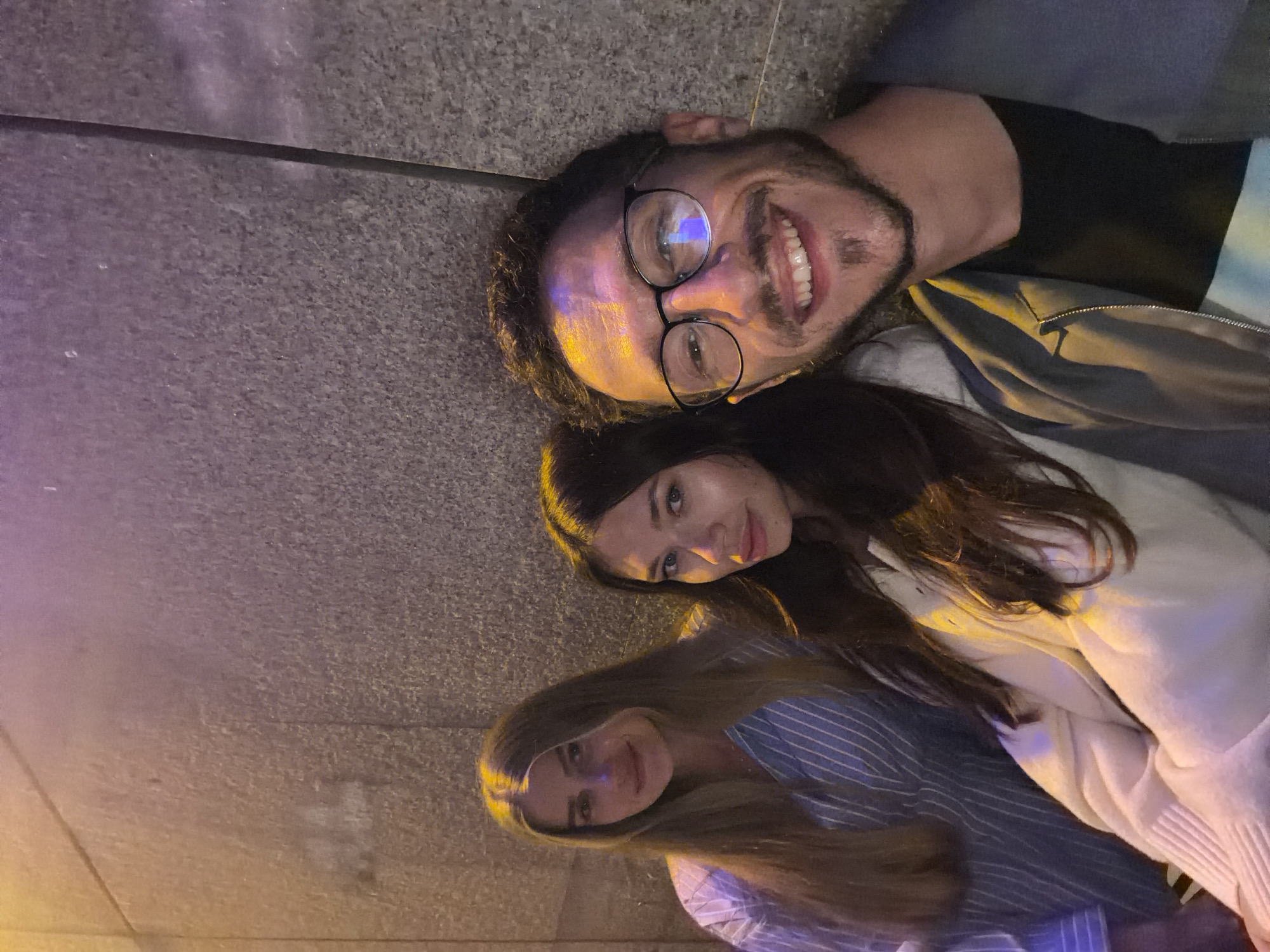 Three people lying on pavement in Tel Aviv